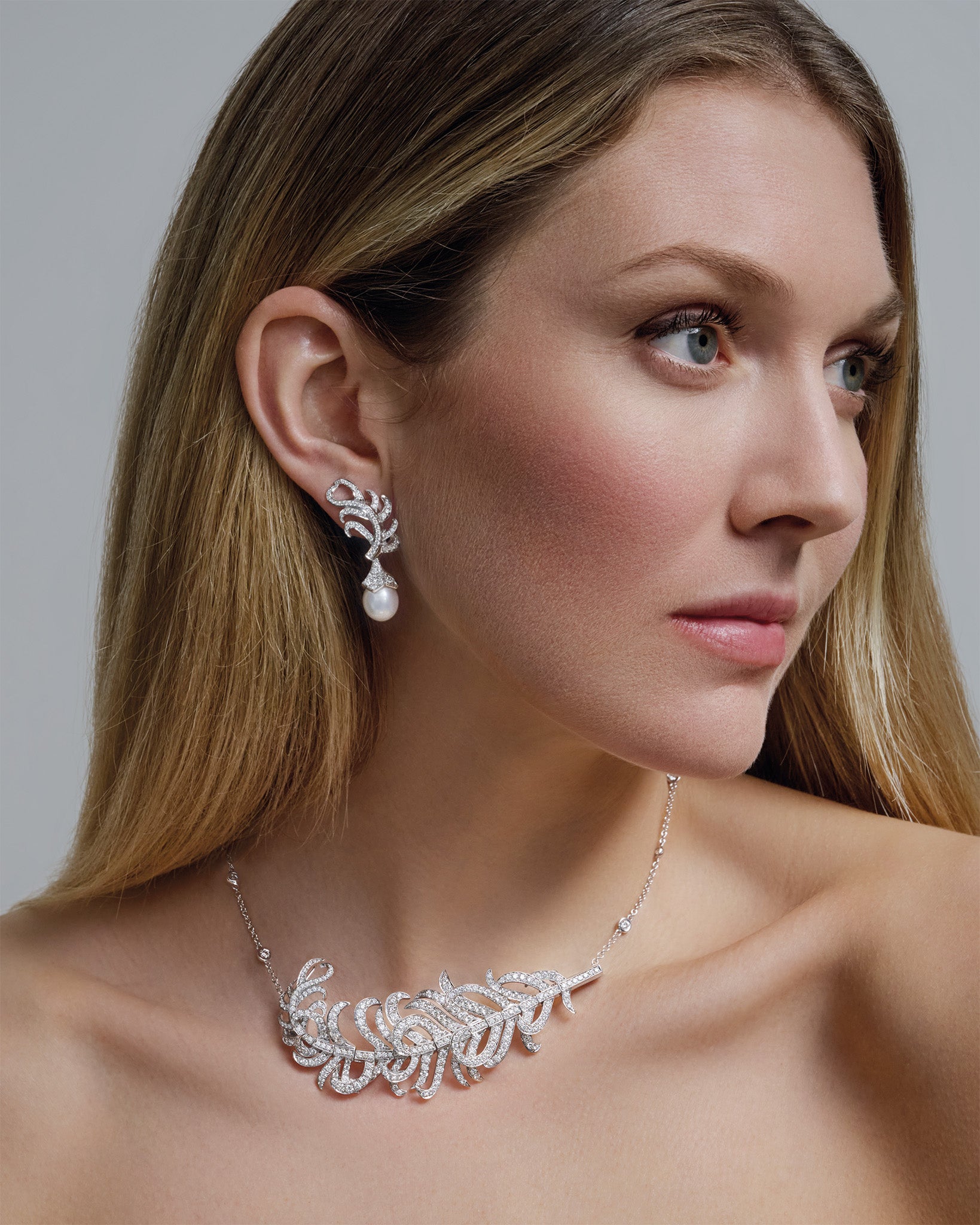 Model wears Feather Plume Masterpiece and earrings.