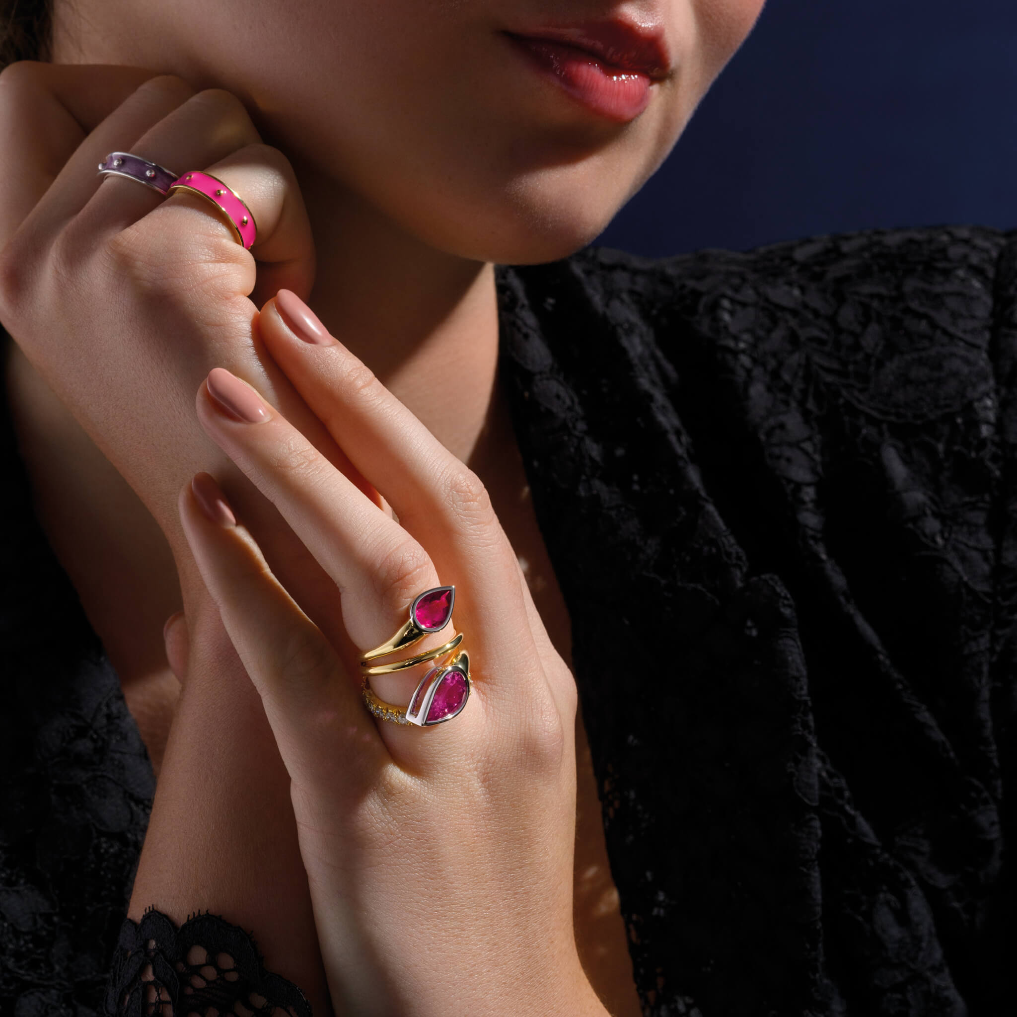 Model wears handcrafted 18ct yellow and white gold swirl ring featuring teardrop shaped pink tourmaline at each end, october birthstone