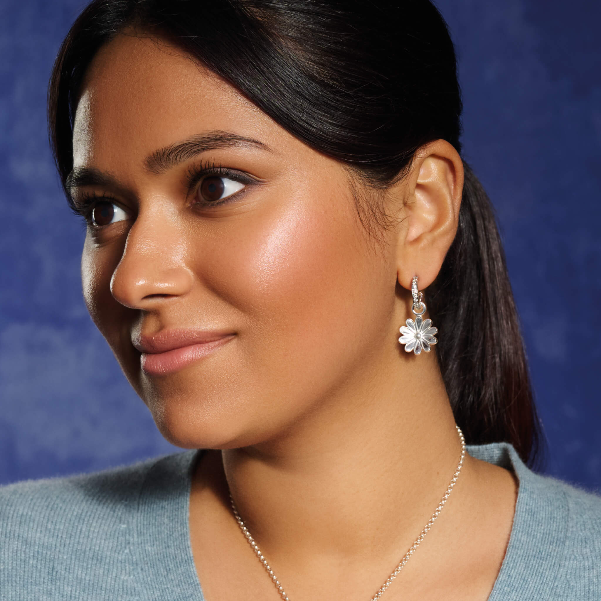Handcrafted earring drops in the shape of an anemone flower in precious metal.