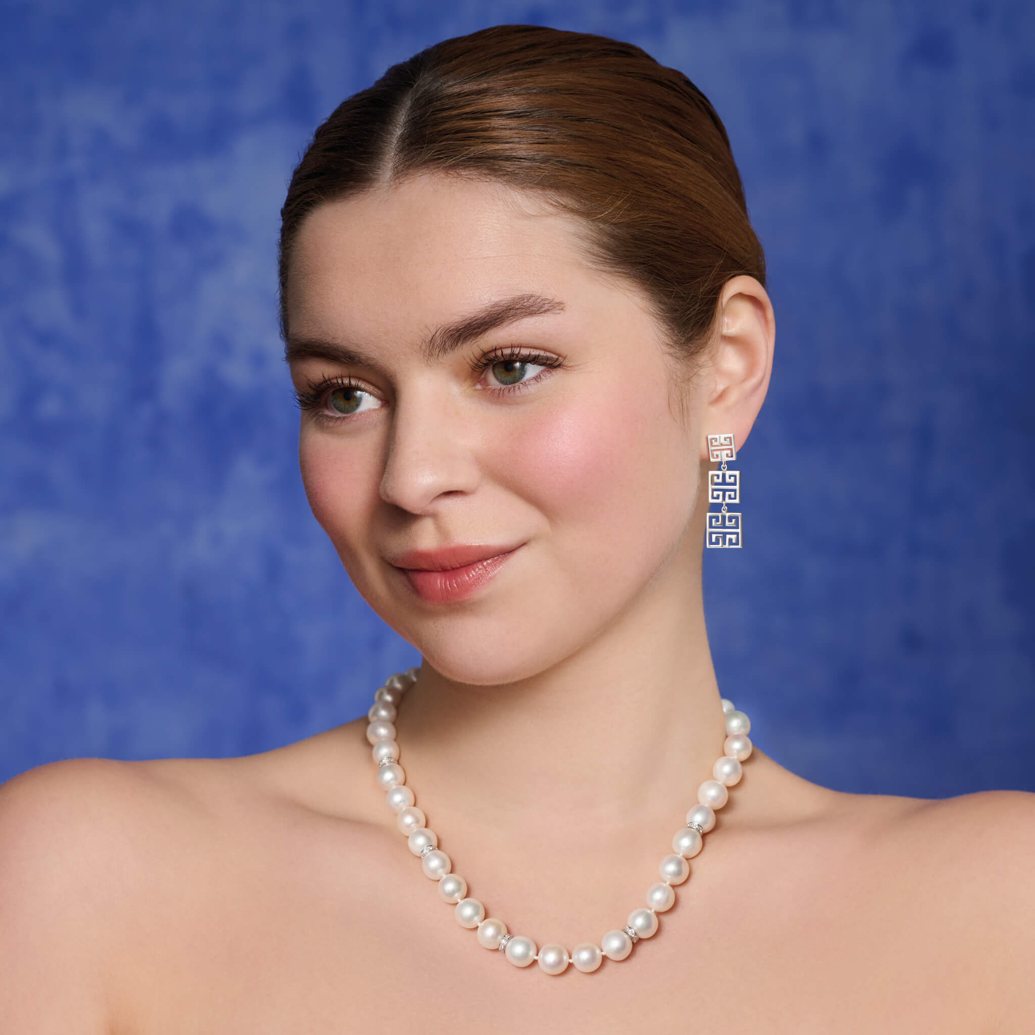 Model wears handcrafted Meandros triple earrings in silver.
