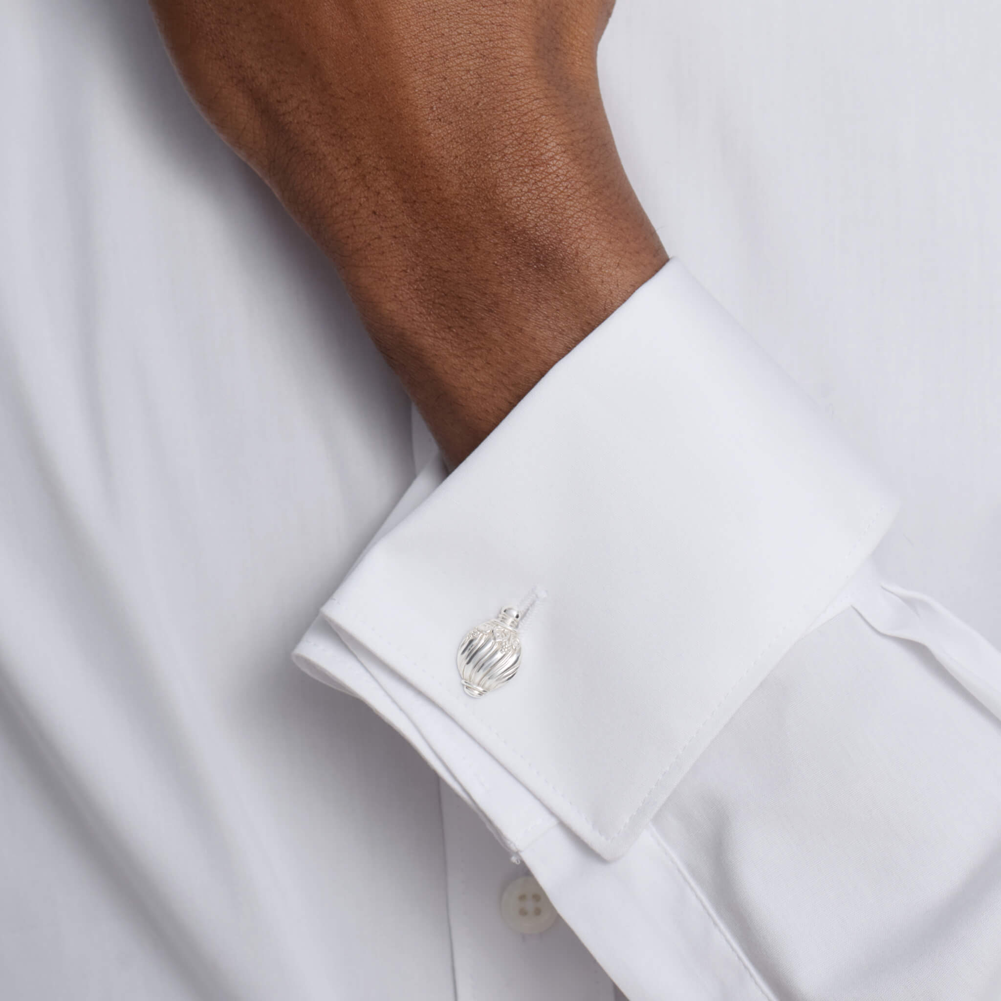 Handcrafted silver double ended cufflinks featuring a shell shape. 