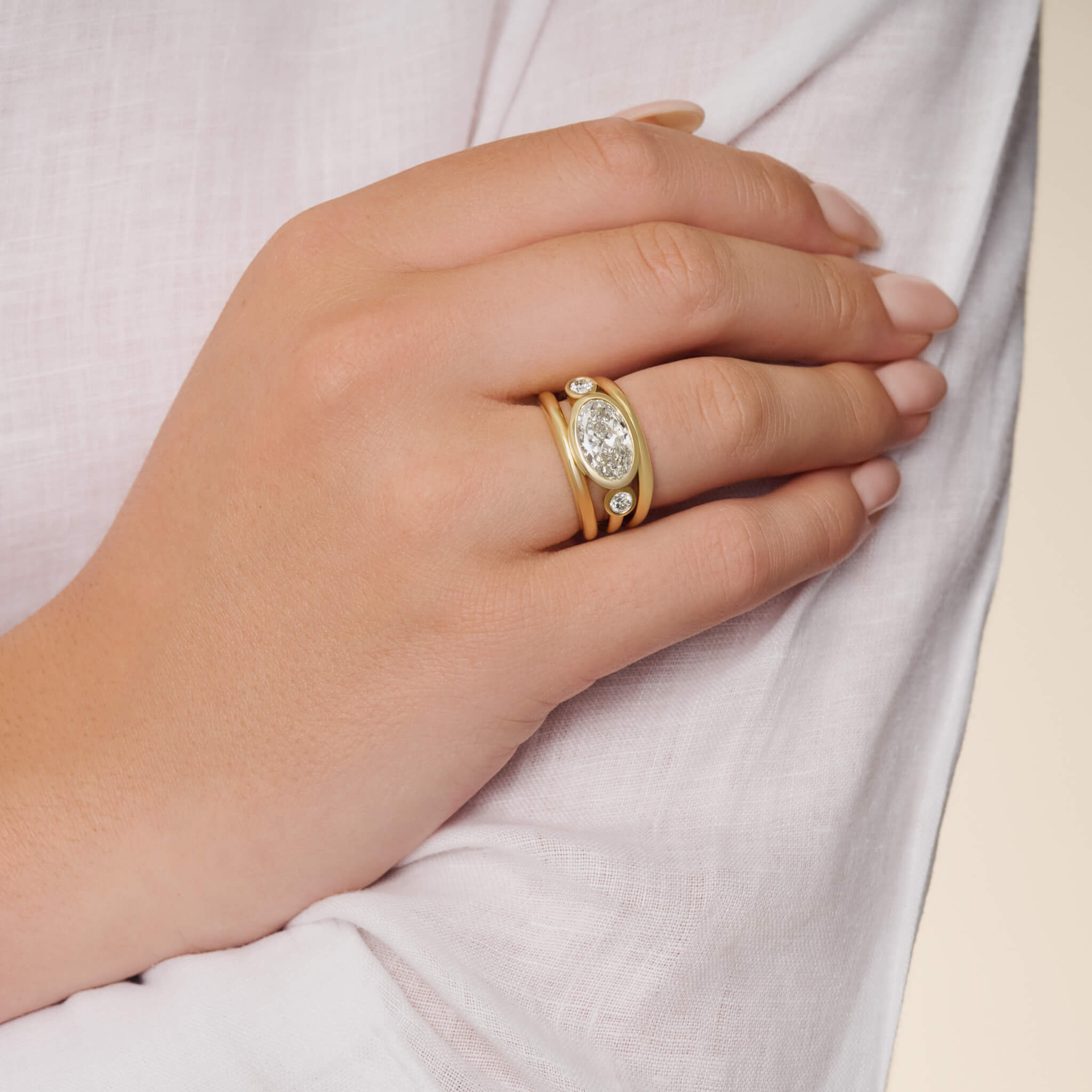 model wearing aeneus ring in 18ct yellow gold with oval diamond by Cassandra Goad, inspired by Aeneas of Troy, gia certified diamonds