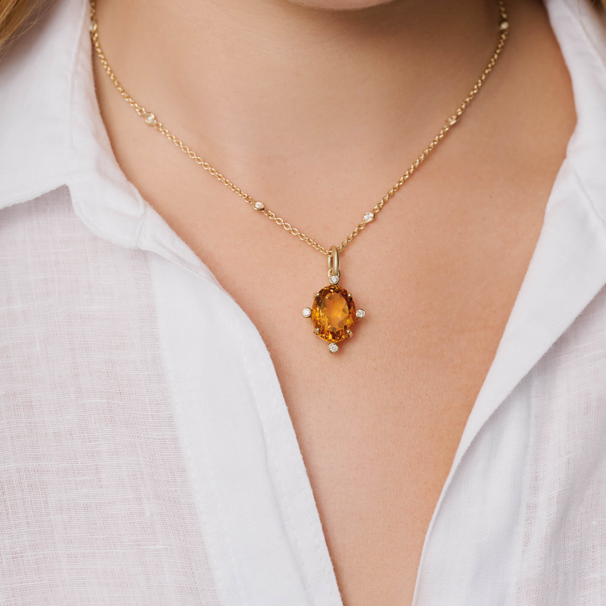 Model wears handcrafted Compass large pendant 9ct yellow gold with citrine set with four diamonds. On gold chain with diamonds.