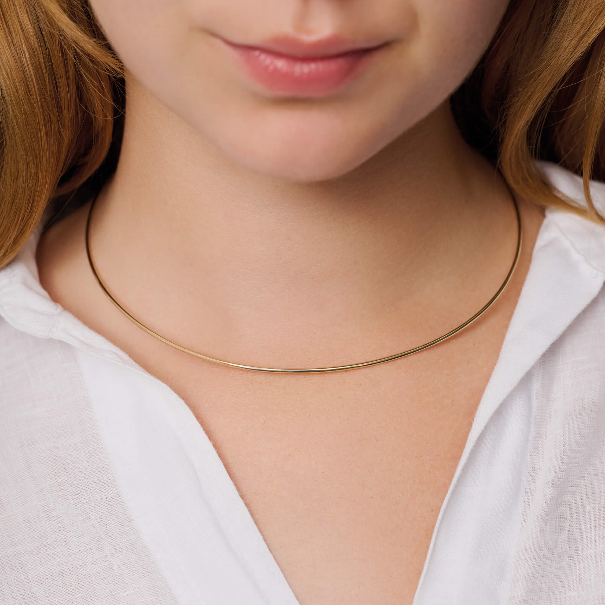 Model wears handcrafted 9ct yellow gold torque necklace inspired by the nymph Calypso.