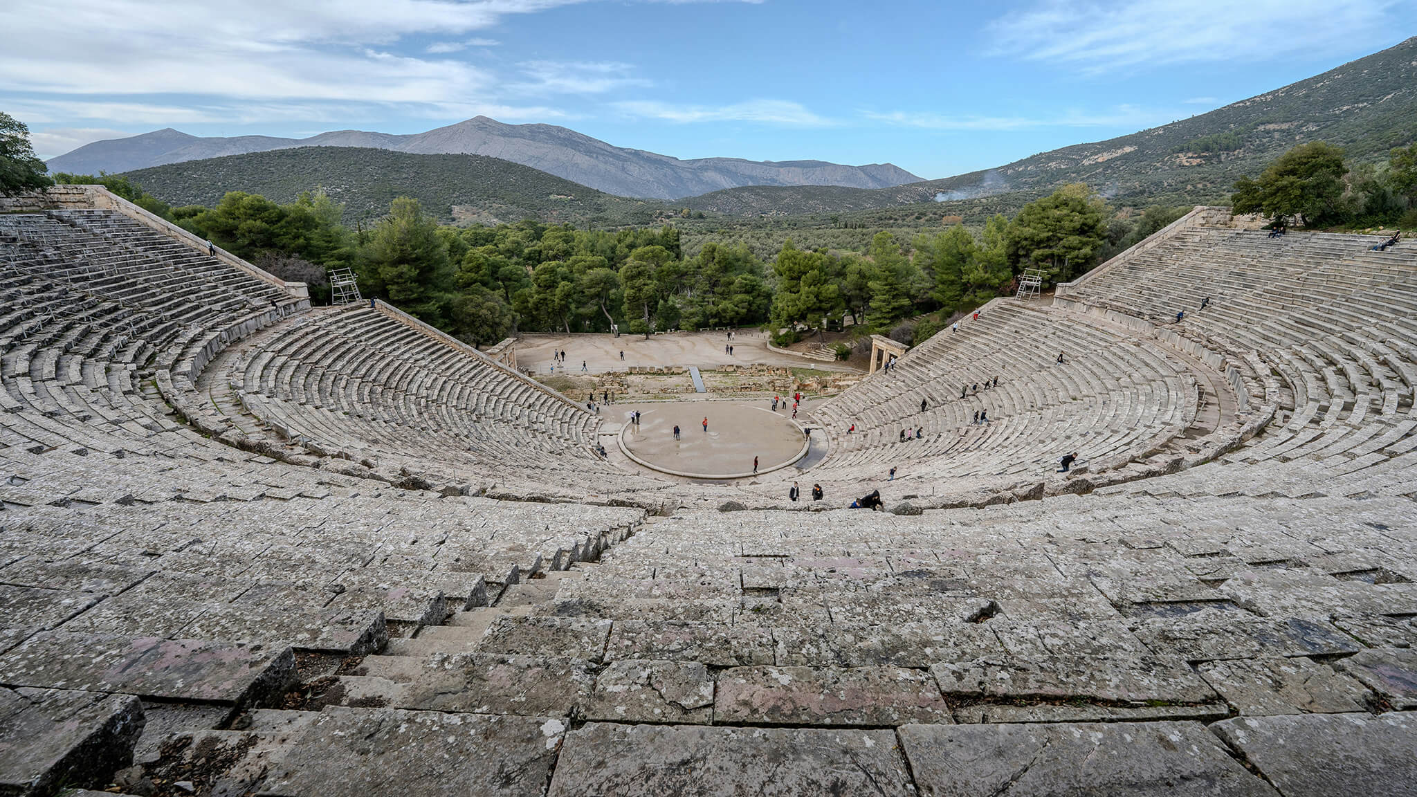 Ancient theater with stone seats and a scenic mountain view, theatre of Epidavros in Greece