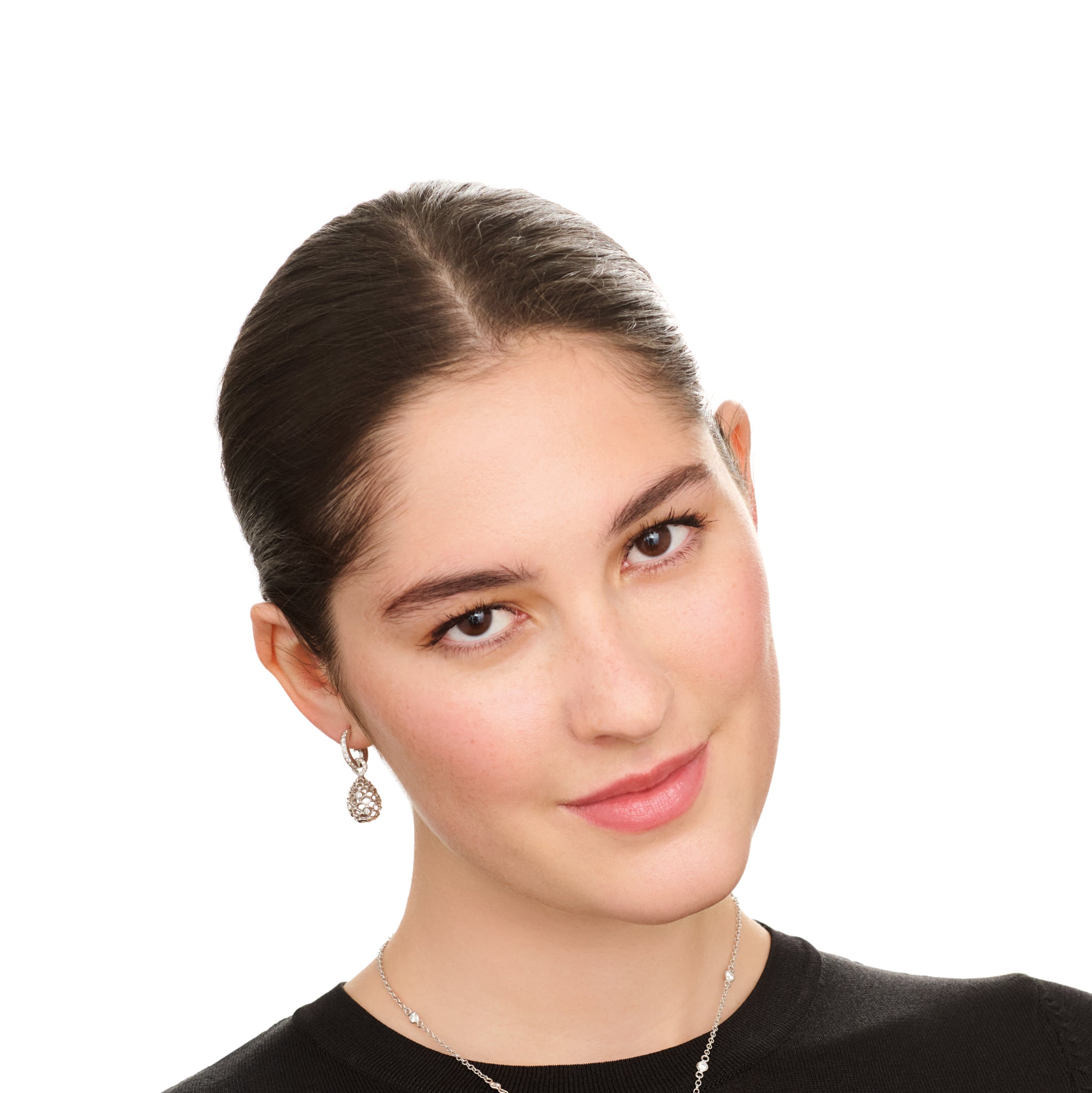 Model wears handcrafted white gold earring drops featuring a pinecone frame with diamonds.