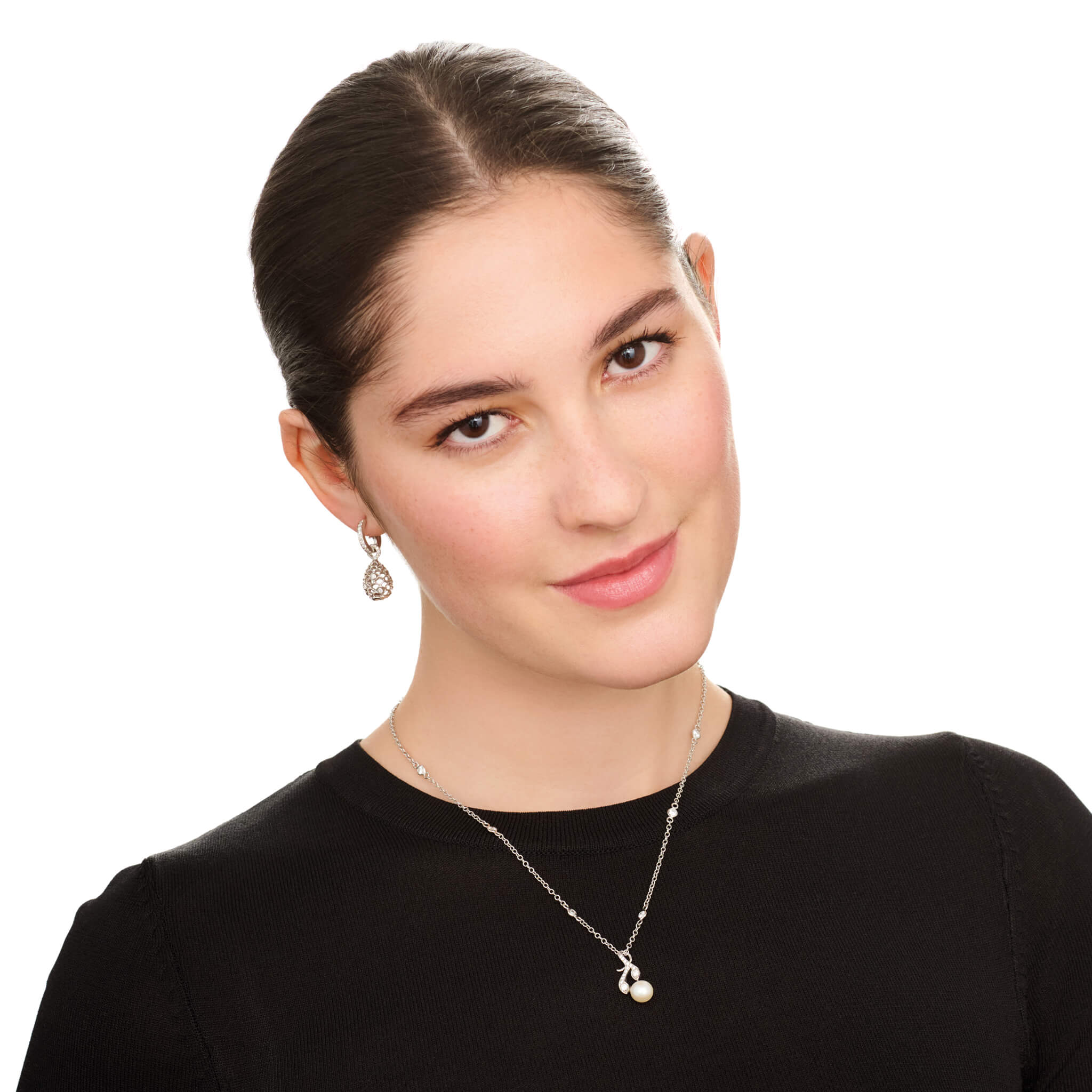 Model wears handcrafted white gold earring drops featuring a pinecone frame with diamonds.