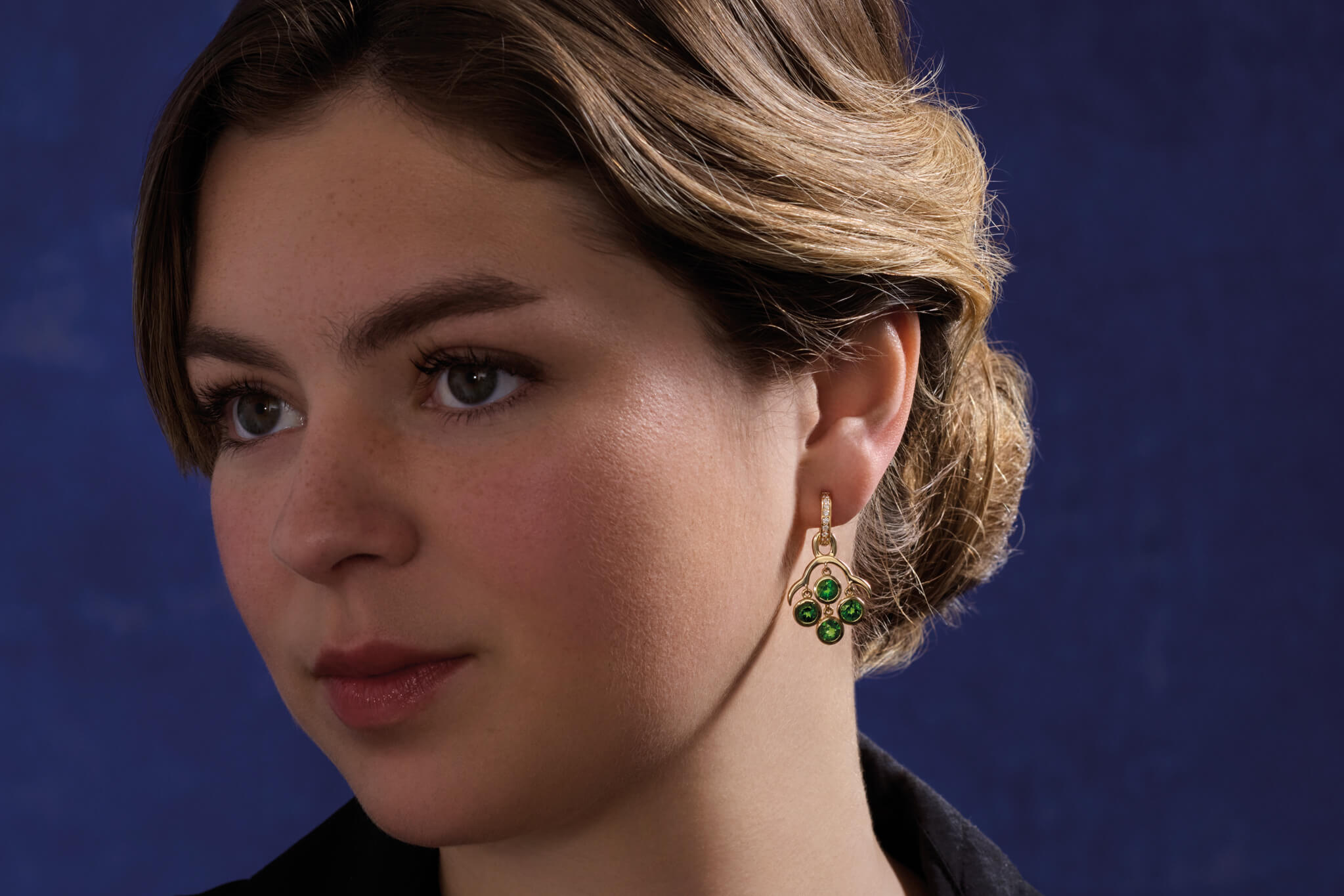 model wears Acai earrings with four facetted green chrome diopside gemstones. A Cassandra Goad design also worn by Catherine, Princess of Wales.