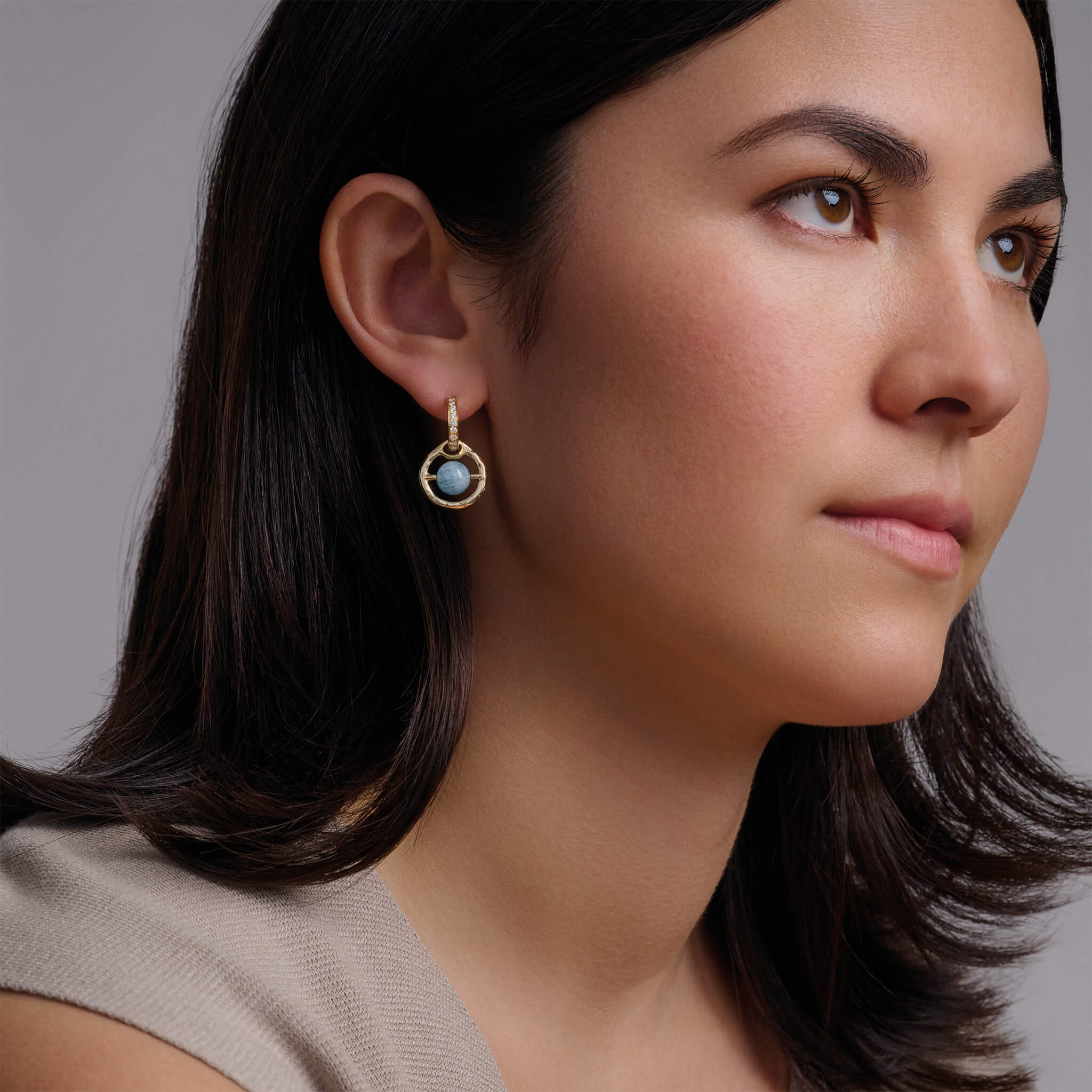 Model wearing Archipelago earrings with aquamarine.