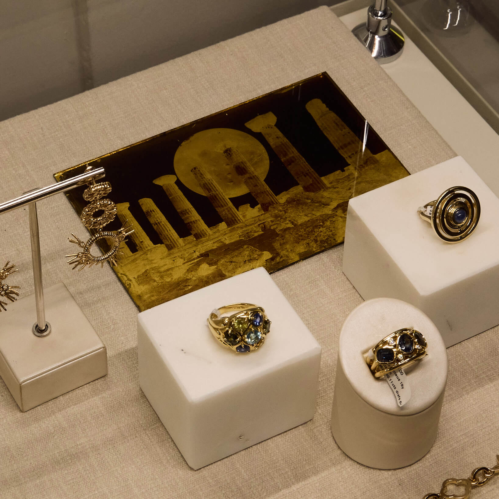 Cassandra Goad boutique display of jewels featuring Fran May's art work. 