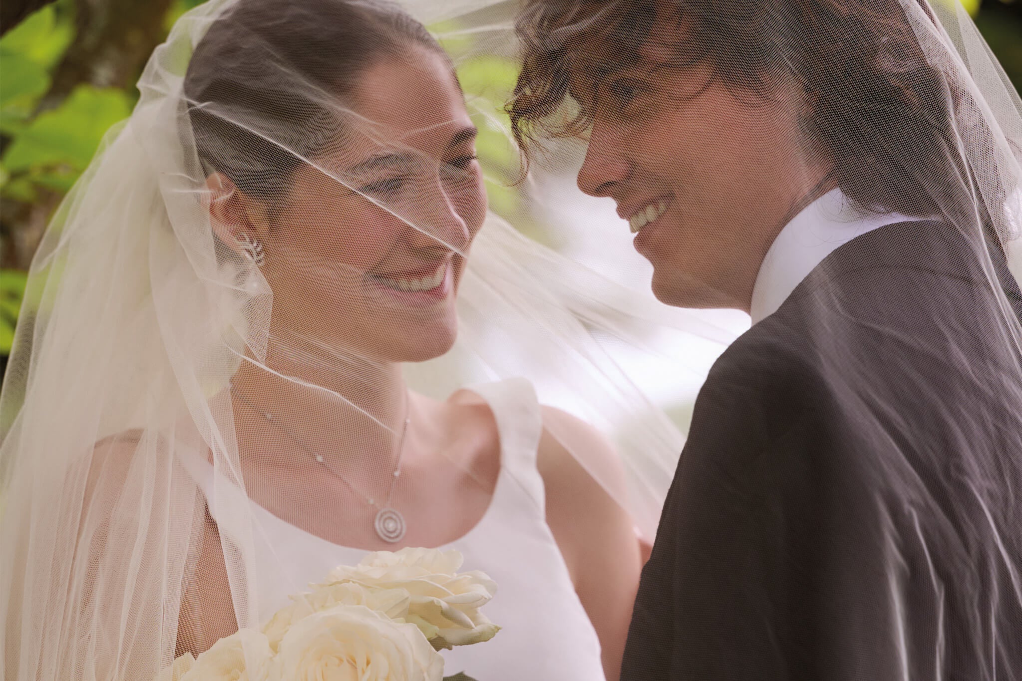 bride and groom on their wedding day wearing cassandra goad handcrafted bridal jewellery