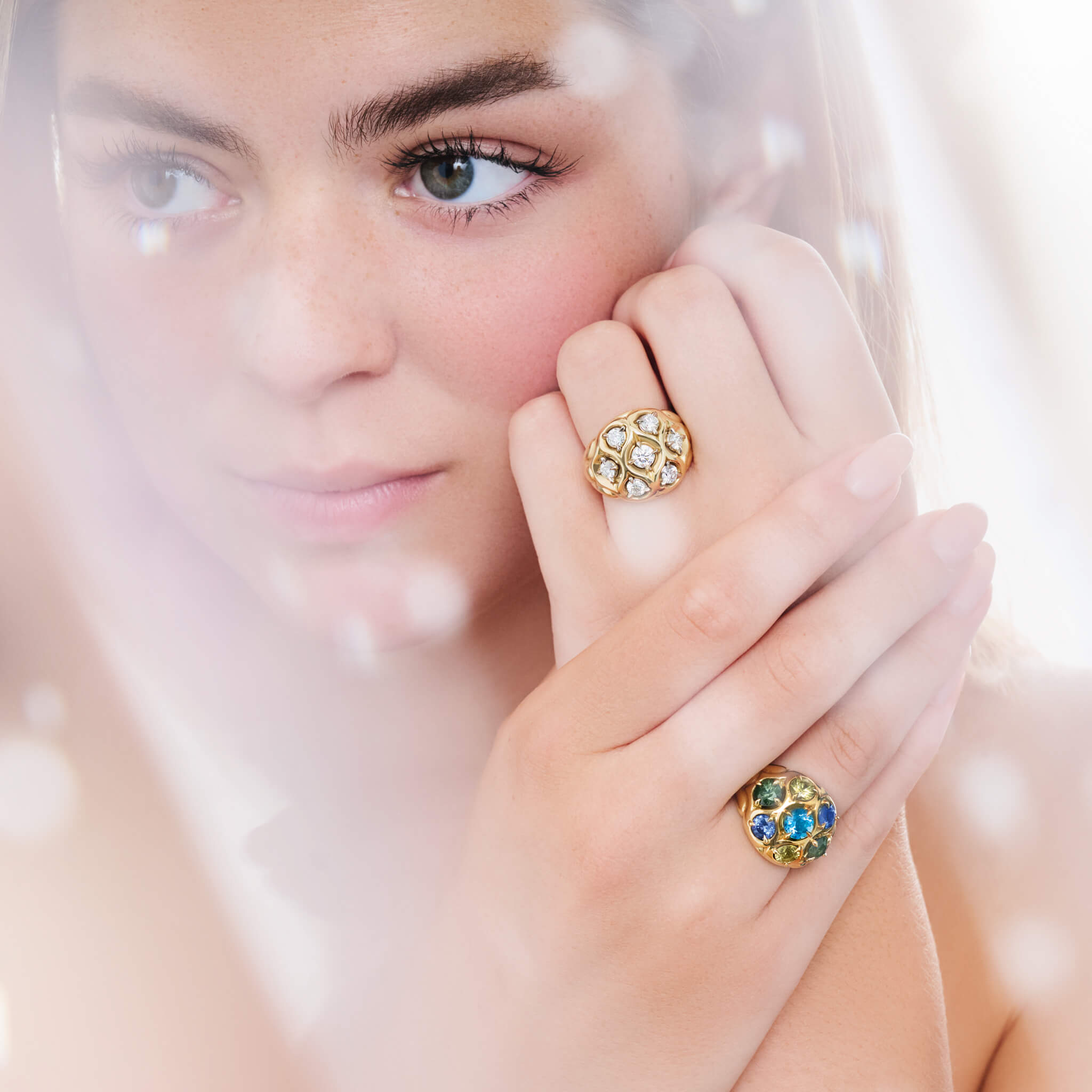 Model wears handcrafted 18ct yellow gold cocktail rings with diamond, aquamarine and coloured sapphires. The perfect cocktail rings for Christmas gifting and festive styling.