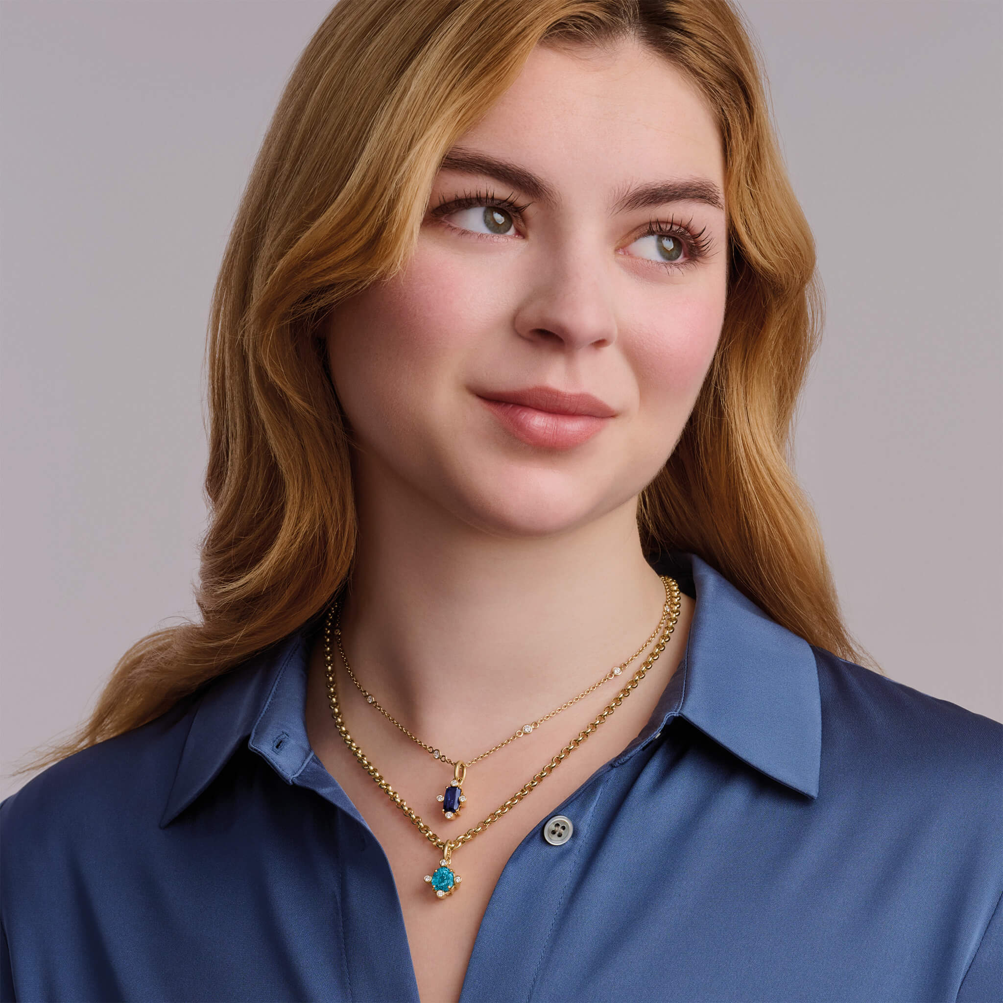 Handcrafted 18ct yellow gold pendant with medium facetted blue zircon set with four diamonds