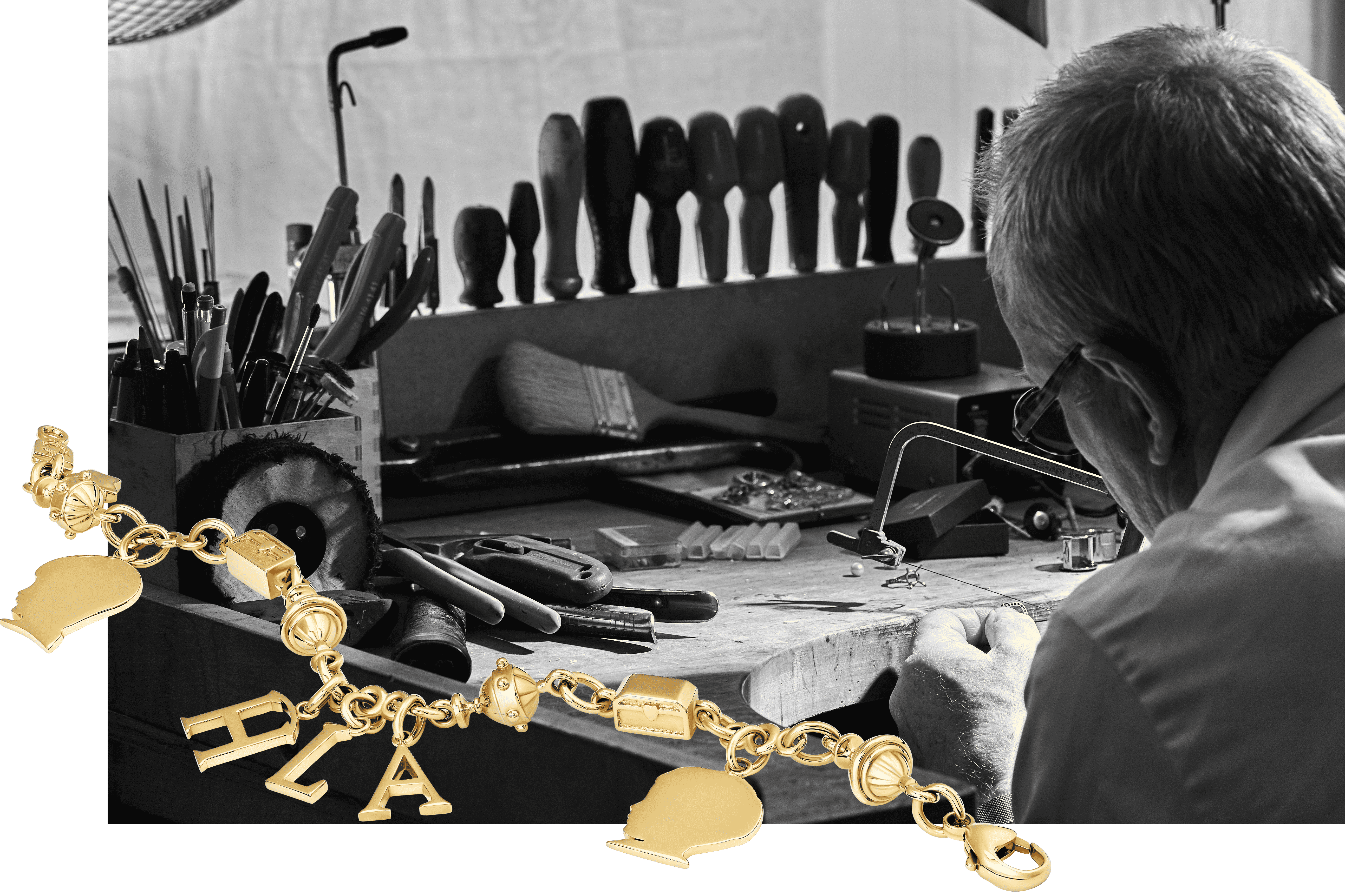 Craftsman working on a bespoke jewellery project, cutting out the yellow gold silhouette pendants for a yellow gold bracelet.