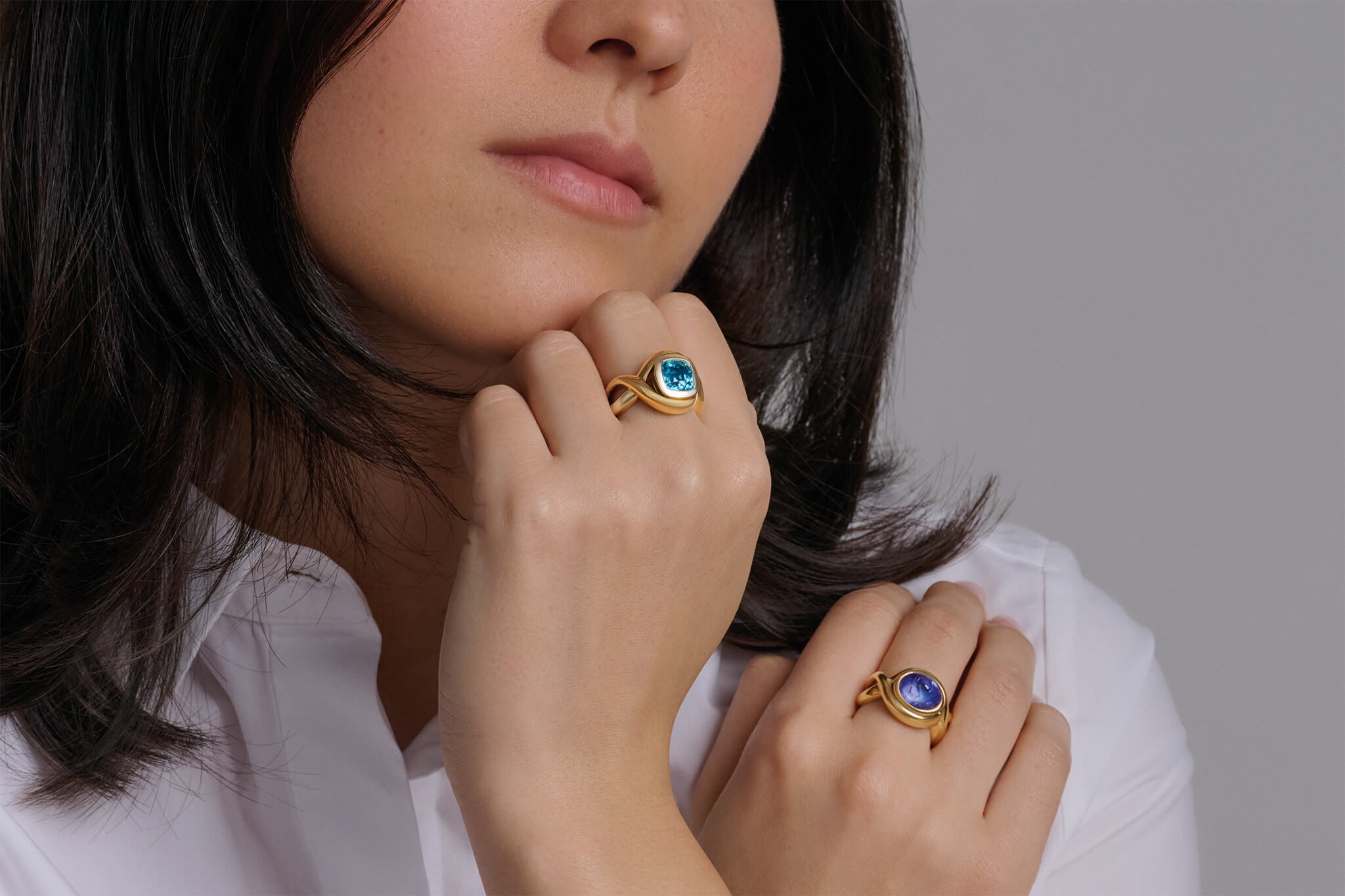 Model wearing blue zircon and tanzanite Severine rings the december birthstones.