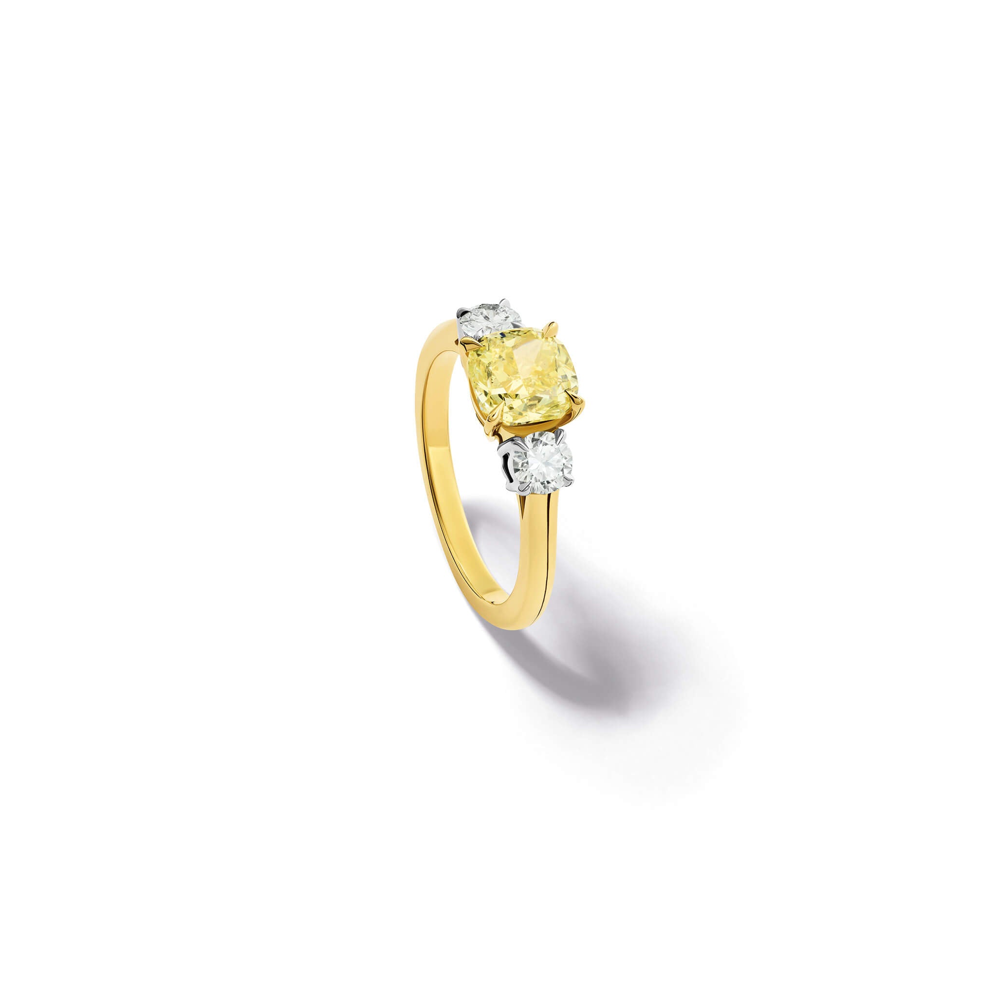 Handcrafted yellow gold yellow diamond engagement ring with two diamonds set in white gold on each side