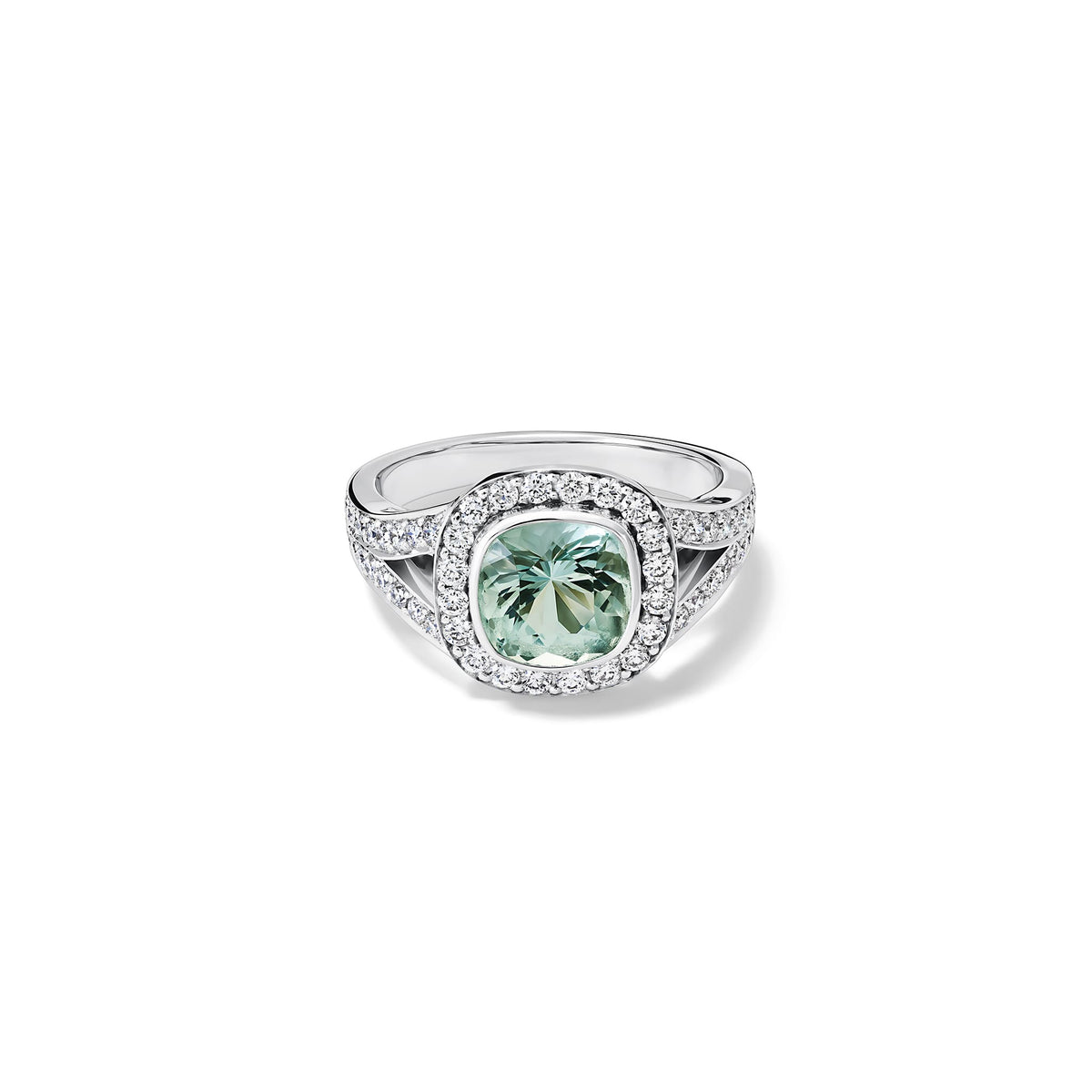 Handcrafted 18ct white gold engagement ring featuring a large, cushion-cut green aquamarine surrounded by a halo of small diamonds and smaller diamonds embedded along the band, March birthstone