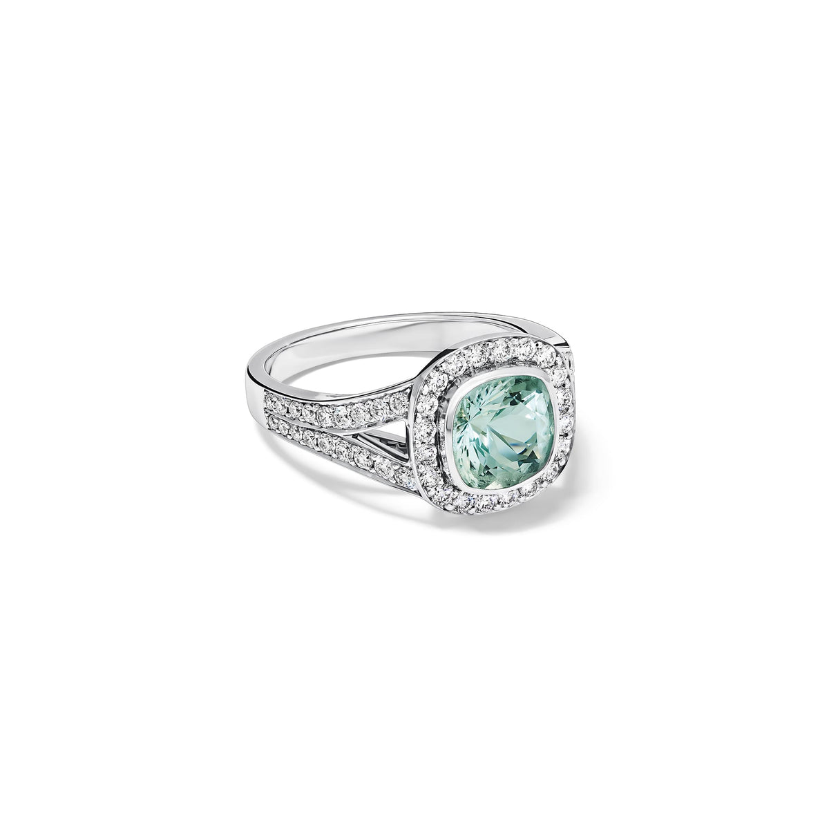 Handcrafted 18ct white gold engagement ring featuring a large, cushion-cut green aquamarine surrounded by a halo of small diamonds and smaller diamonds embedded along the band, March birthstone