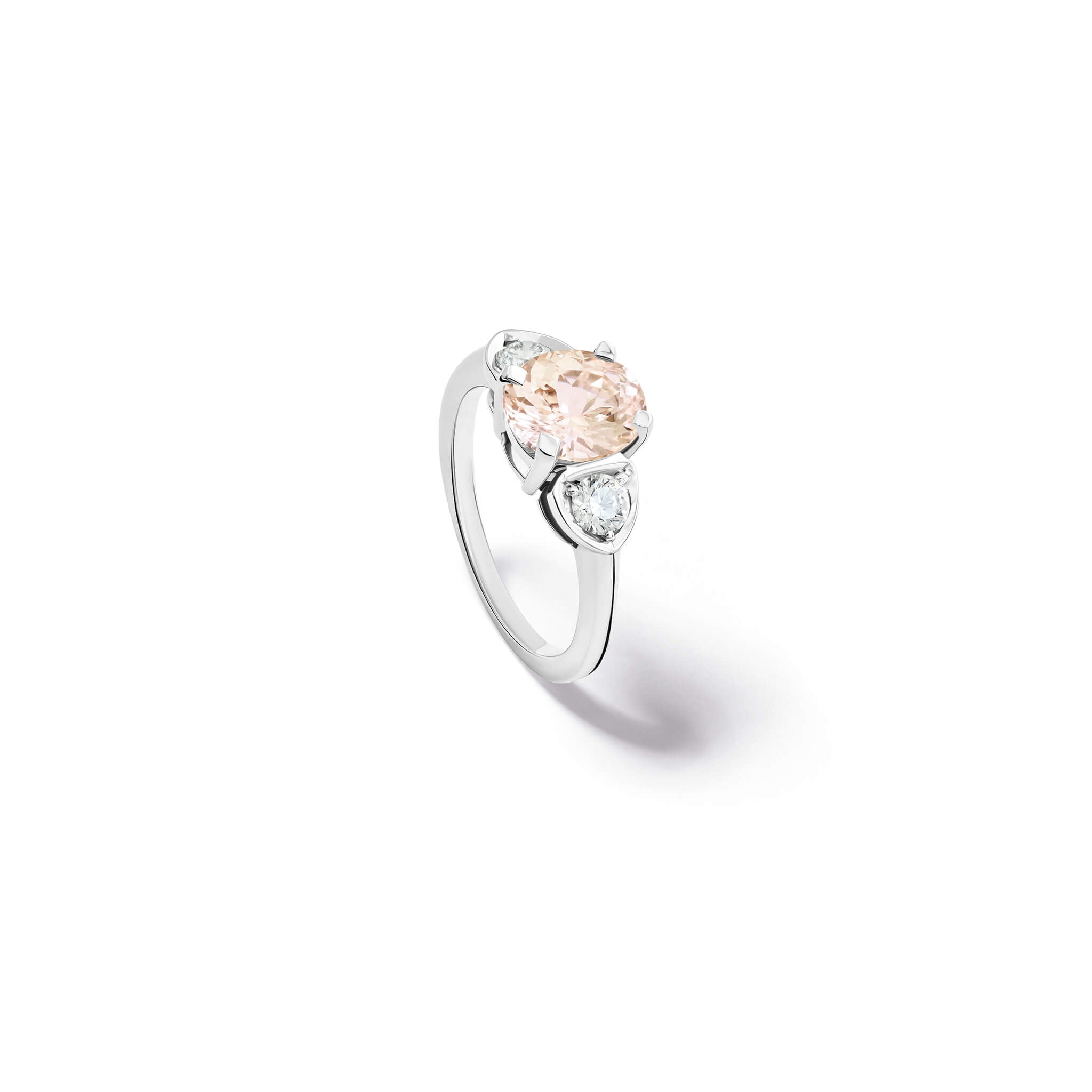 Handcrafted 18ct white gold engagement ring featuring a large central oval light pink sapphire flanked by one smaller teardrop-shaped diamond on each side.