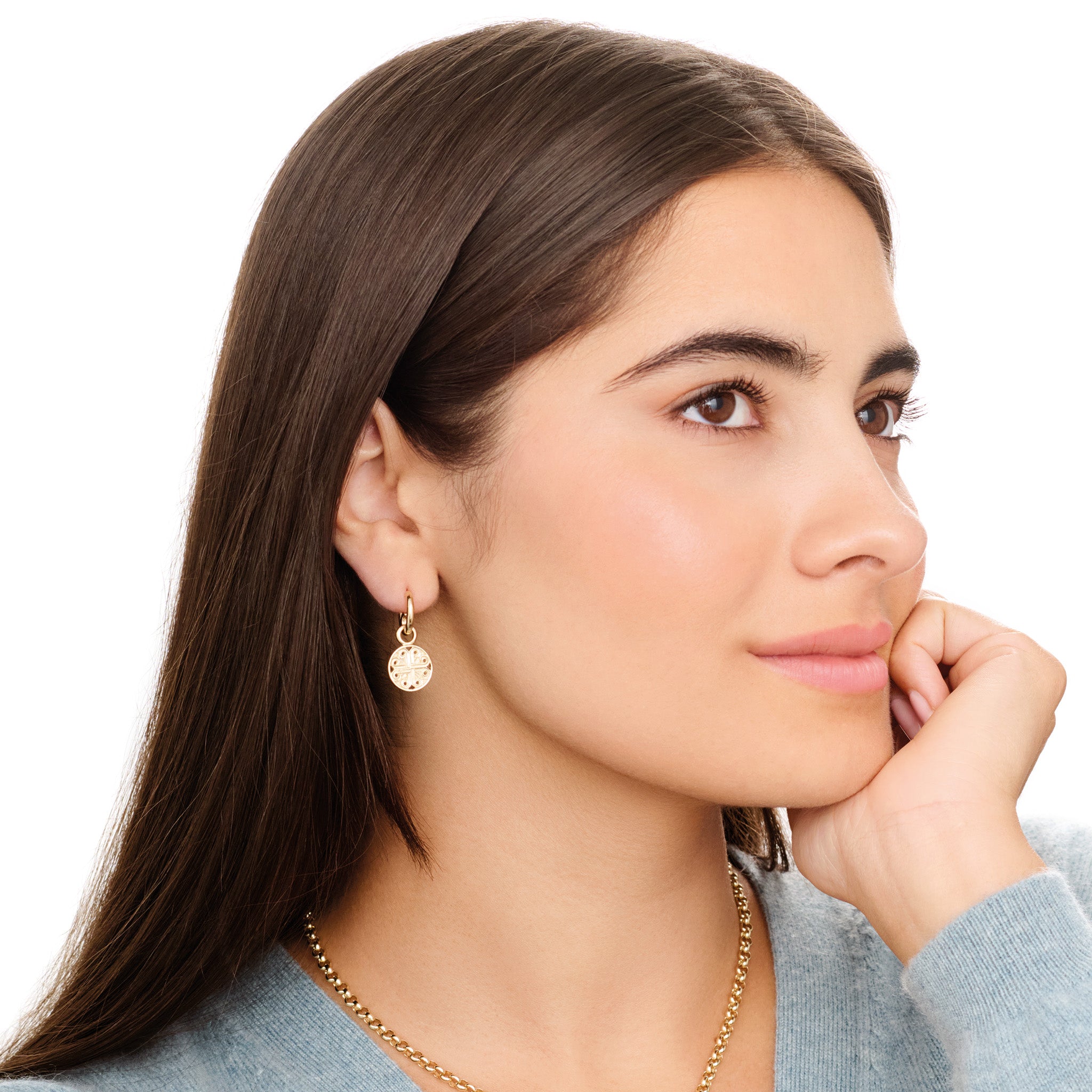 Model wears handcrafted interchangeable 9ct yellow gold circular earring drops with a cross-like motif in the centre.