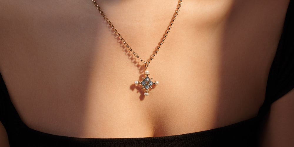 Model wearing Madrid cross with blue topaz and pearls