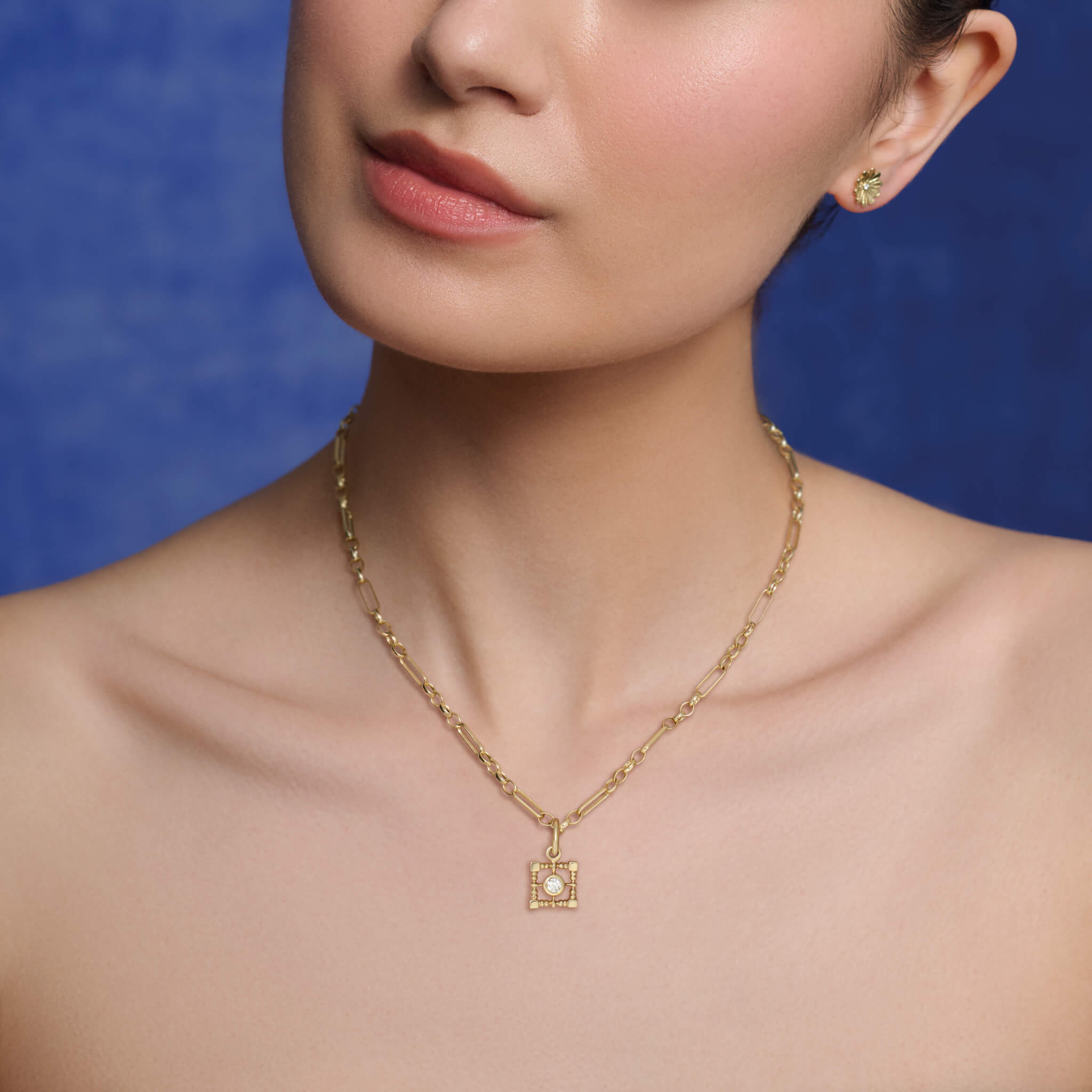 Model wears Cassandra Goad Mashrabiya Trellis Square pendant in pearl.