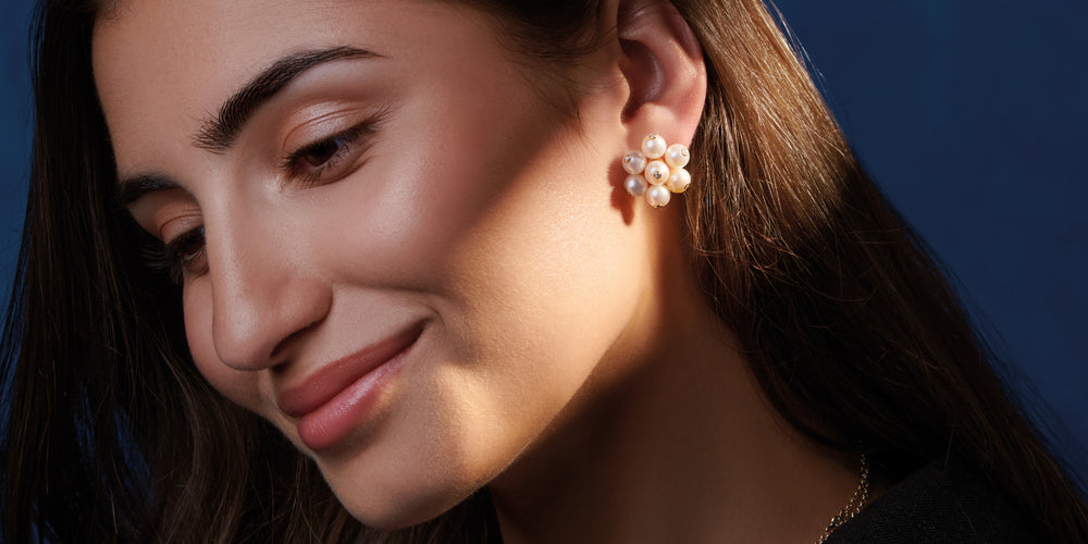 model wearing cavolfiore pearl and diamond earring studs. 