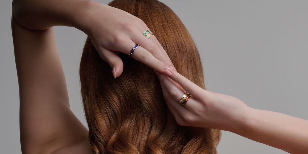 Model posing with hands behind her head wearing Cassandra Goad stacked Decimus rings 