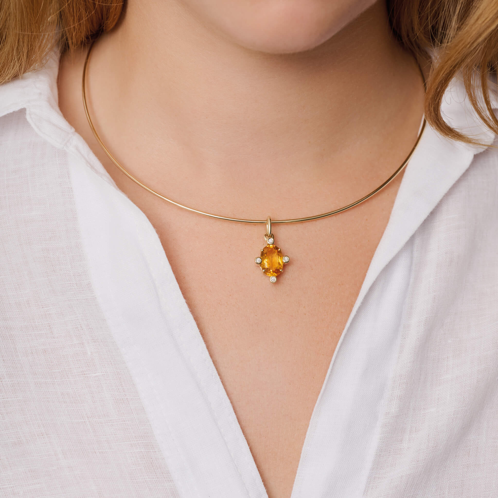 Model wears handcrafted Compass medium pendant 9ct yellow gold with citrine set with four diamonds. On gold chain with diamonds.