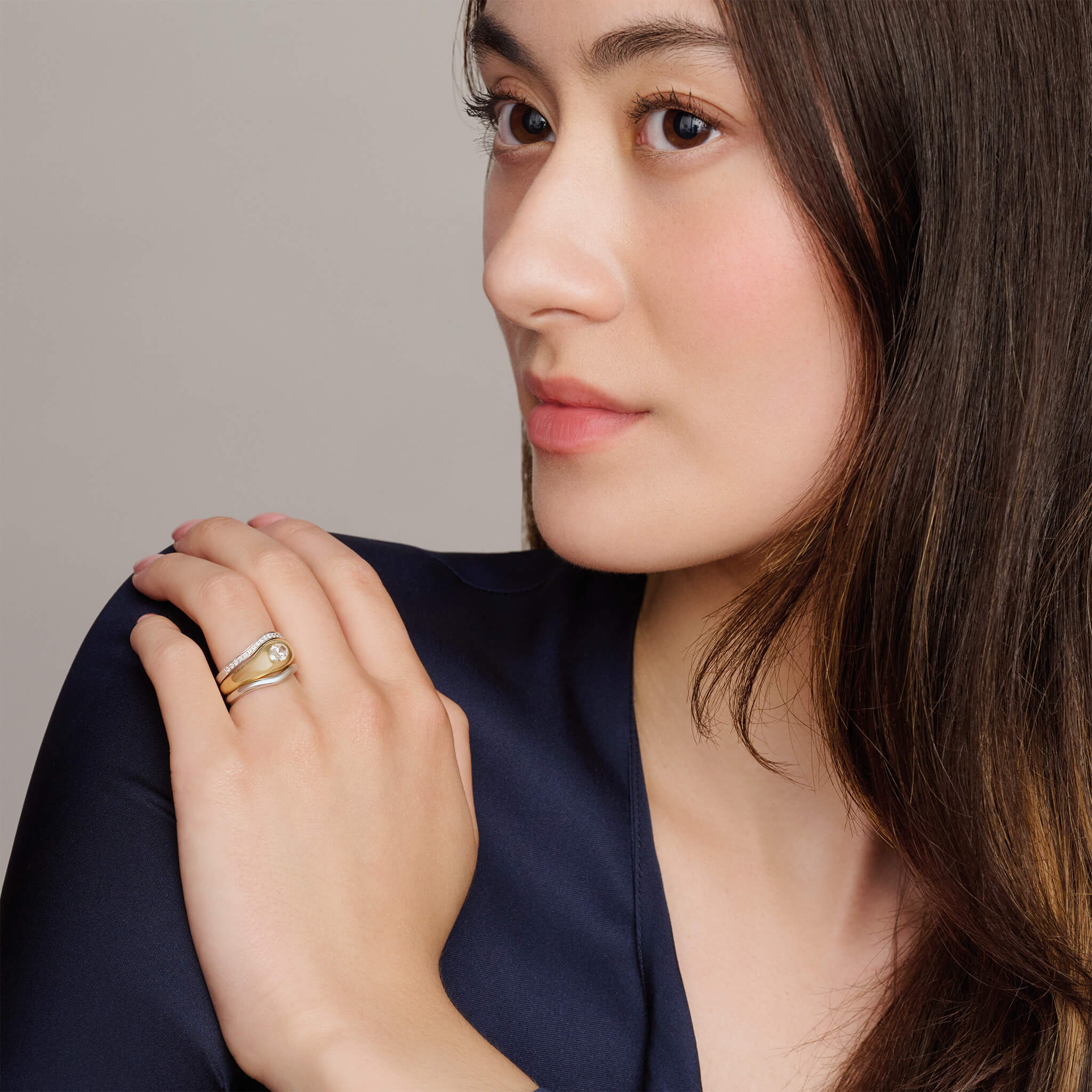 Model wears handcrafted 18ct white gold wedding band set with diamond pave round the band.