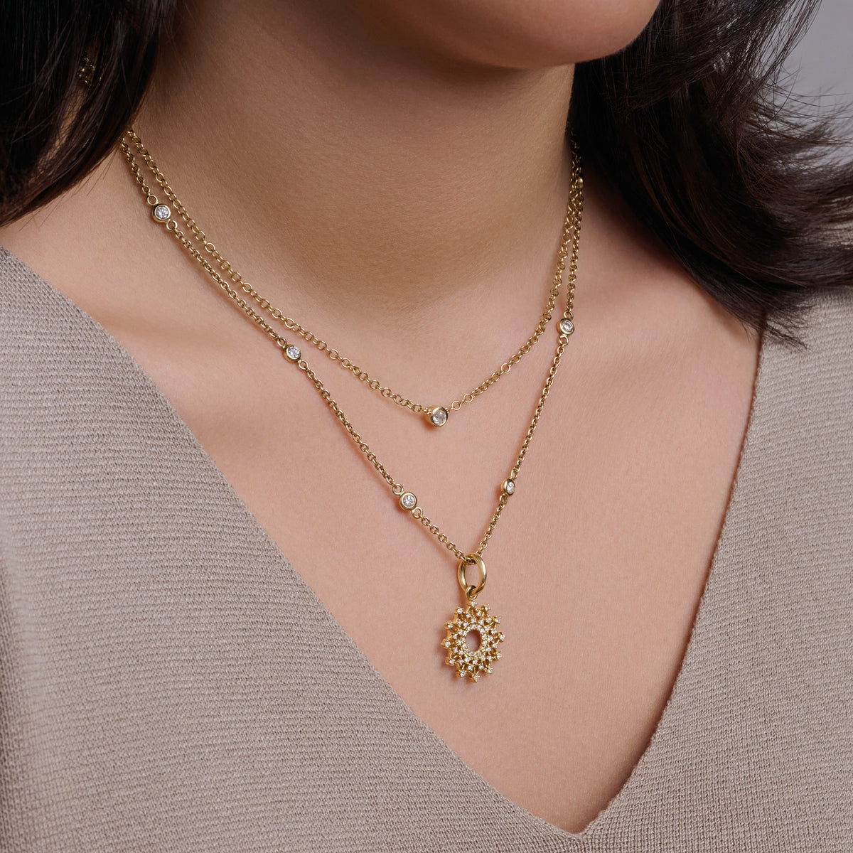 Model wears handcrafted yellow gold necklace with a single medium diamond on an adjustable chain, april birthstone