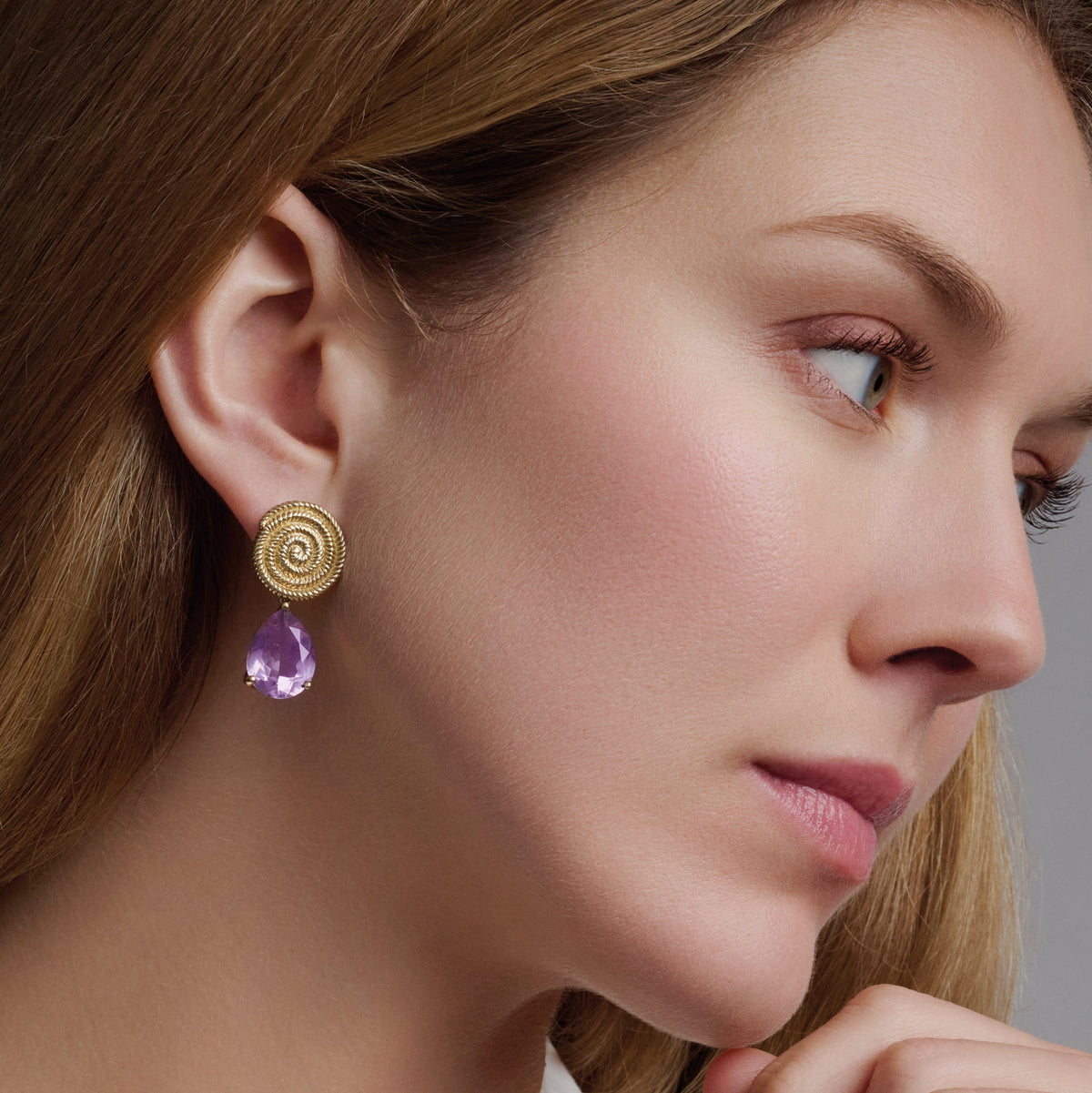 Model wears handcrafted 9ct yellow gold Luiza stud earring pendants with pale facetted amethyst, inspired by Rio de Janeiro, Brazil, February Birthstone