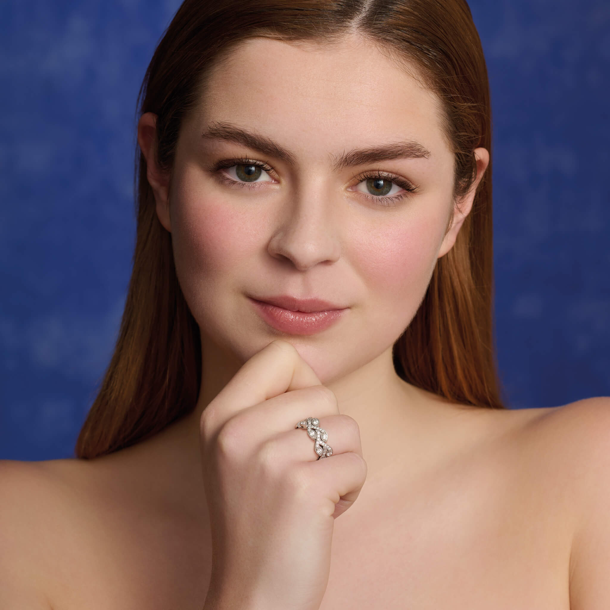 Model wearing a handcrafted 18ct white gold engagement ring resembling rosemary sprigs, embellished with diamonds.