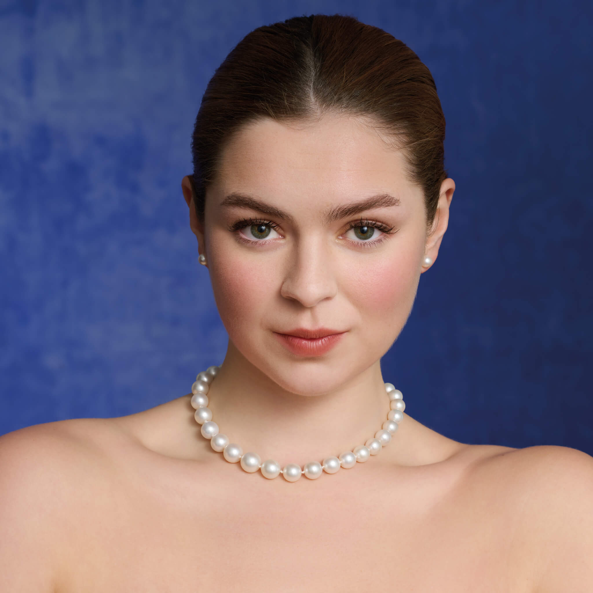Model wears handcrafted South Sea pearl necklace in 18ct yellow gold with slightly graduated pearls.
