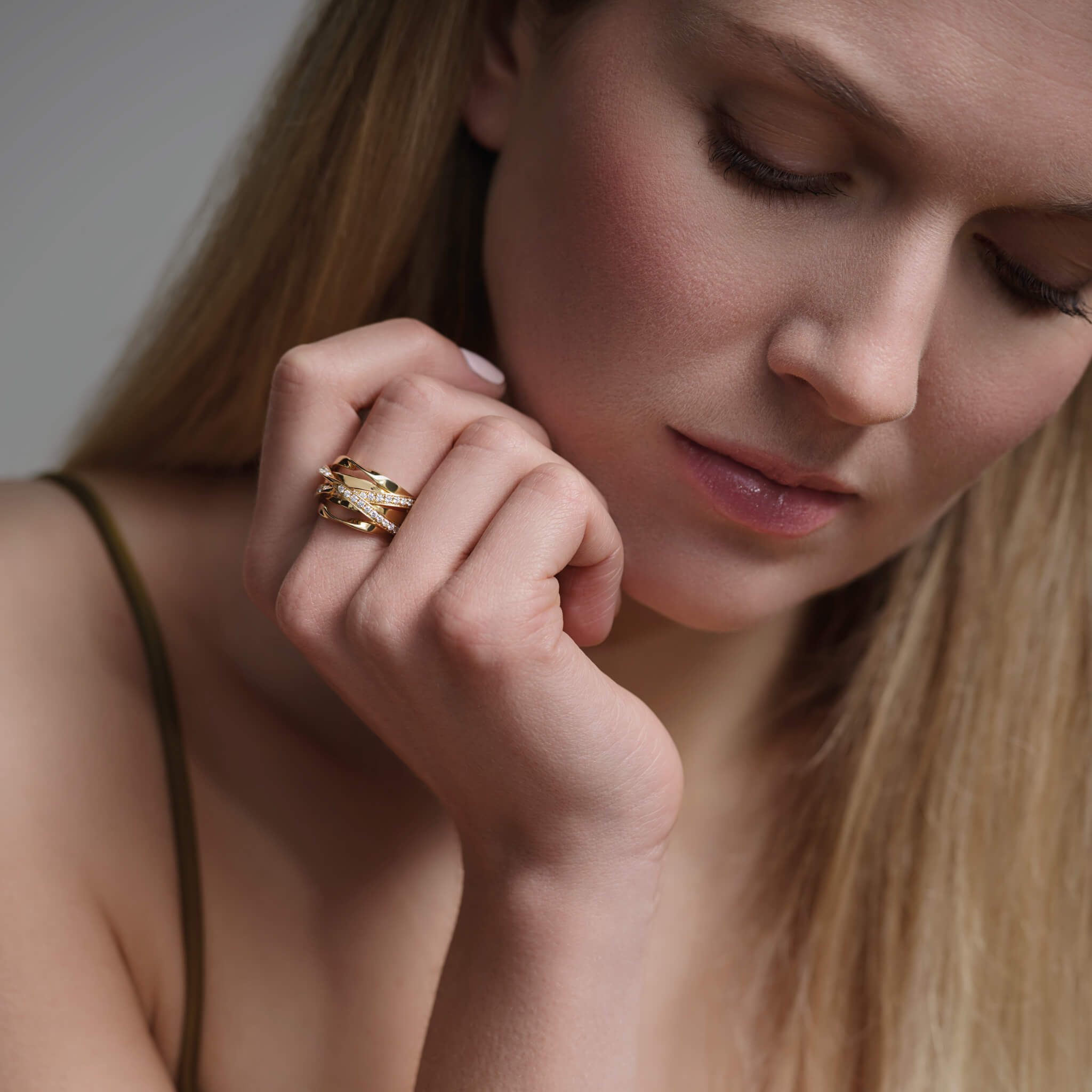 Model wears handcrafted 18ct yellow gold ring featuring a nest of tagliatelle with diamonds.