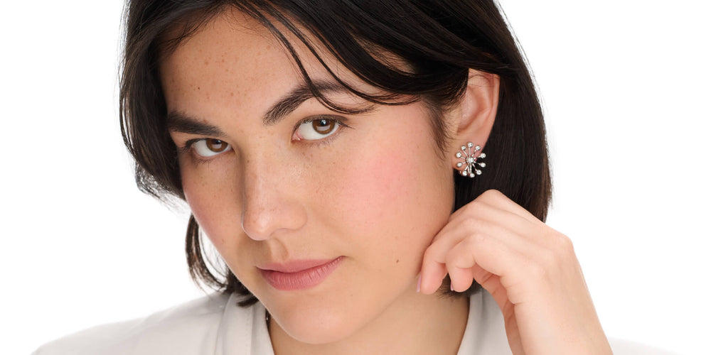 Model looks into the camera wearing Cassandra Goad white gold studs