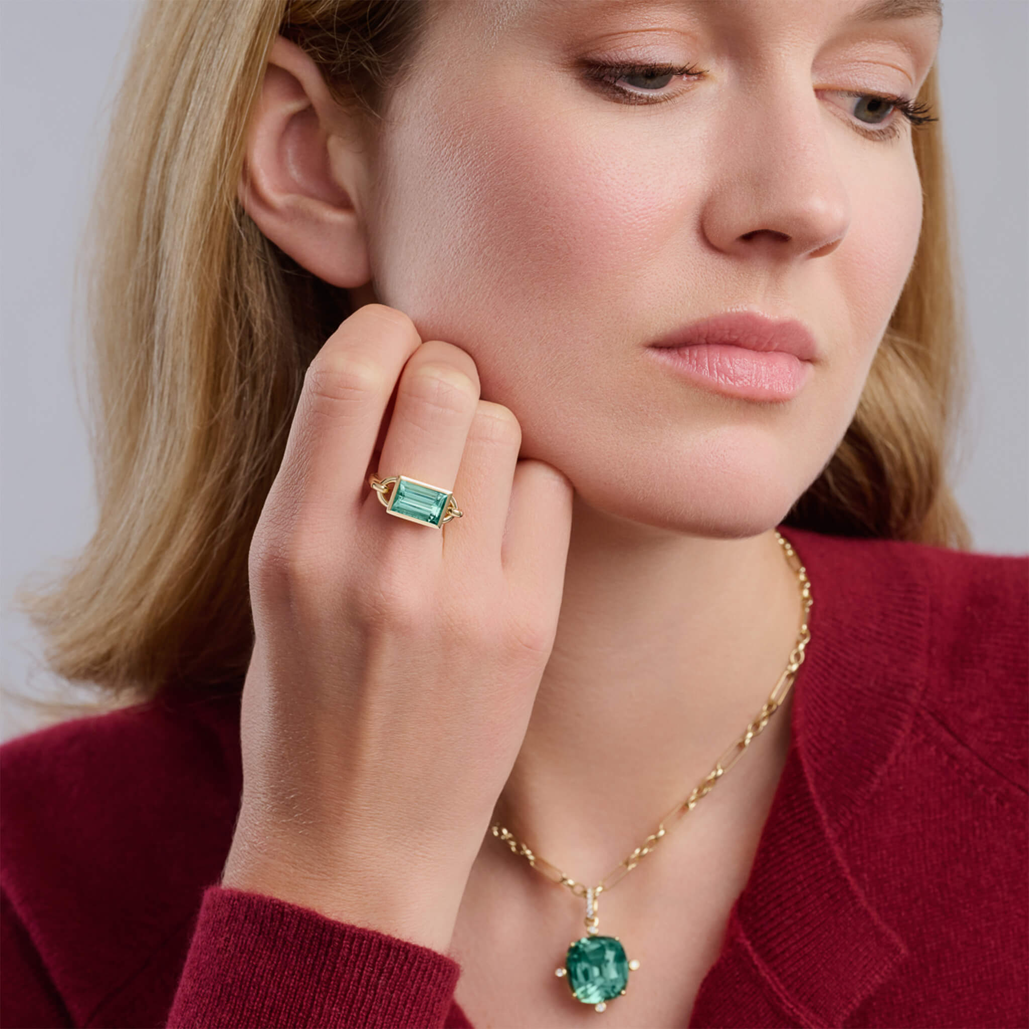 Model wears mint tourmaline large Baguette ring in yellow gold