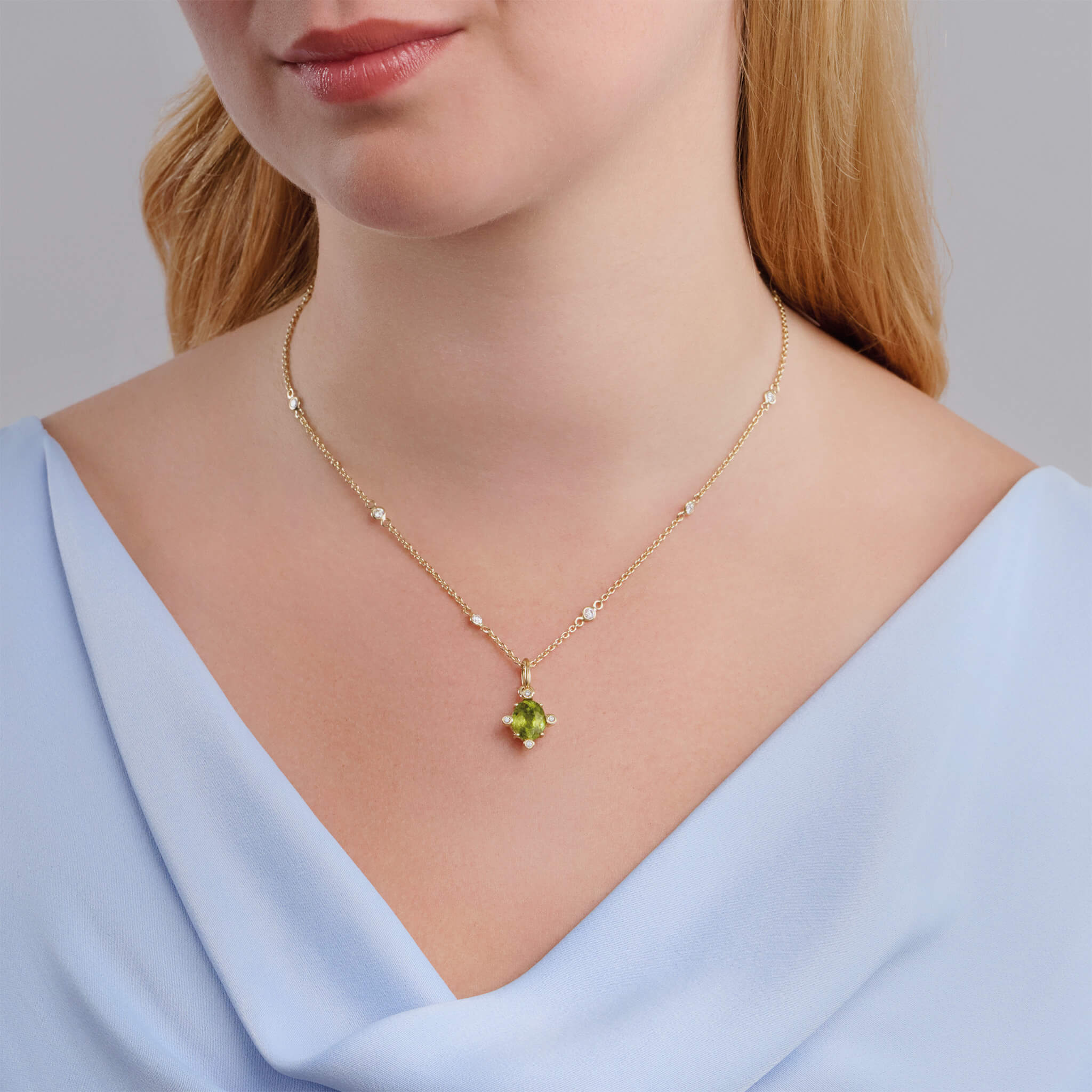 Model wears handcrafted Compass medium necklace pendant in yellow gold with green sphene set with four diamonds.