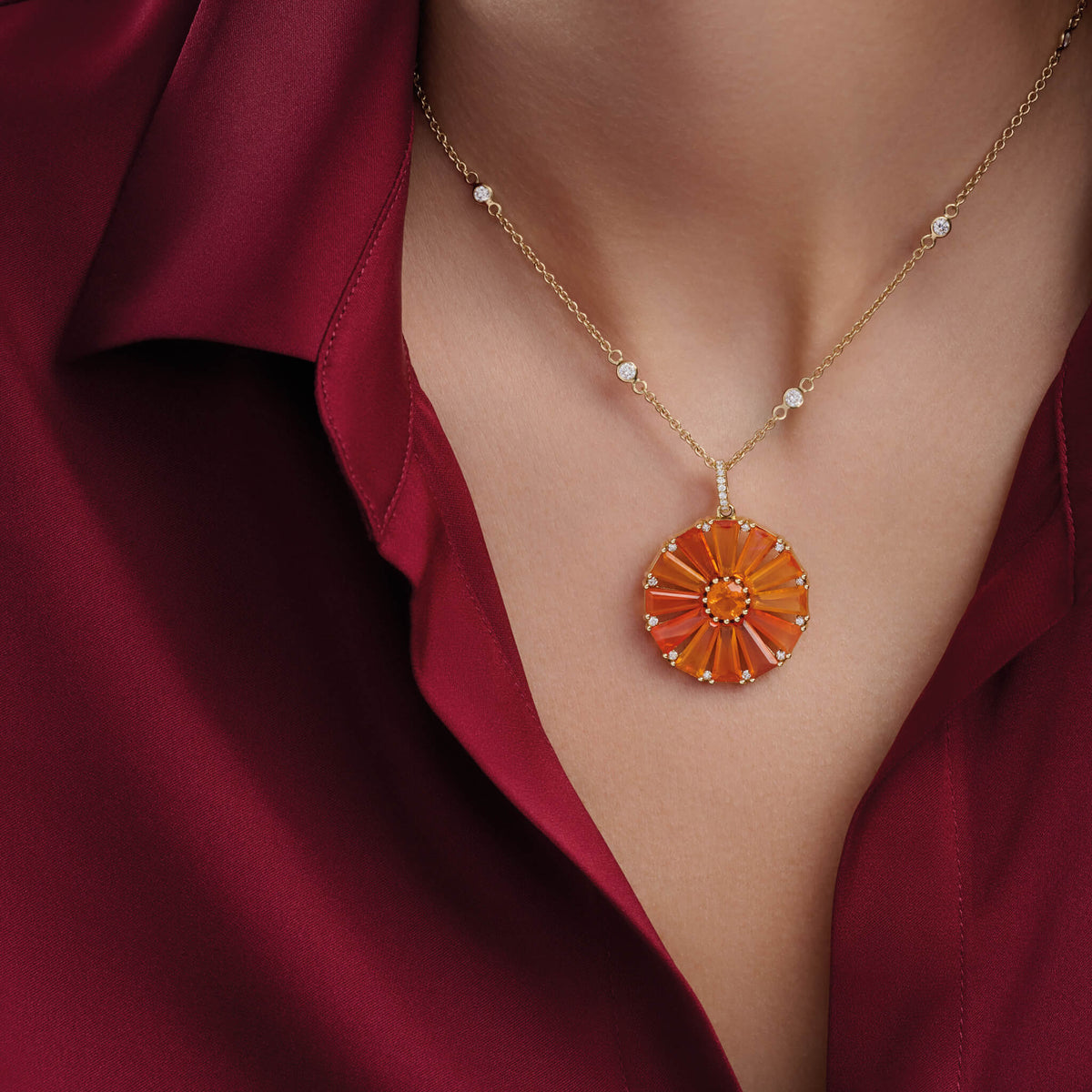 Model wears Roi Soleil necklace pendant handcrafted in 9ct yellow gold with facetted rare orange fire opal and diamond. The birthstone for October.