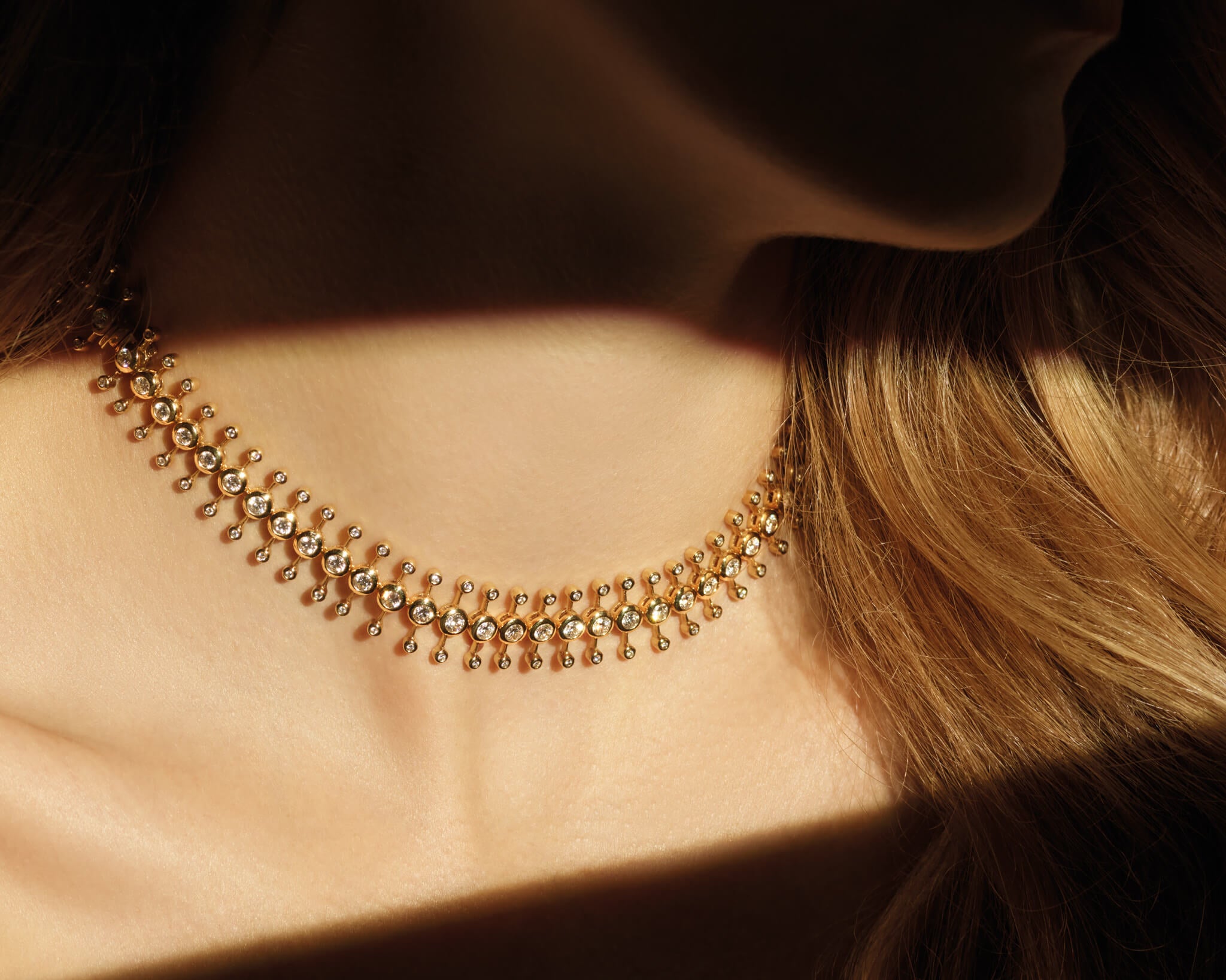 Model wears Mosaic Astrantia necklace  in 18ct Yellow Gold with Diamond