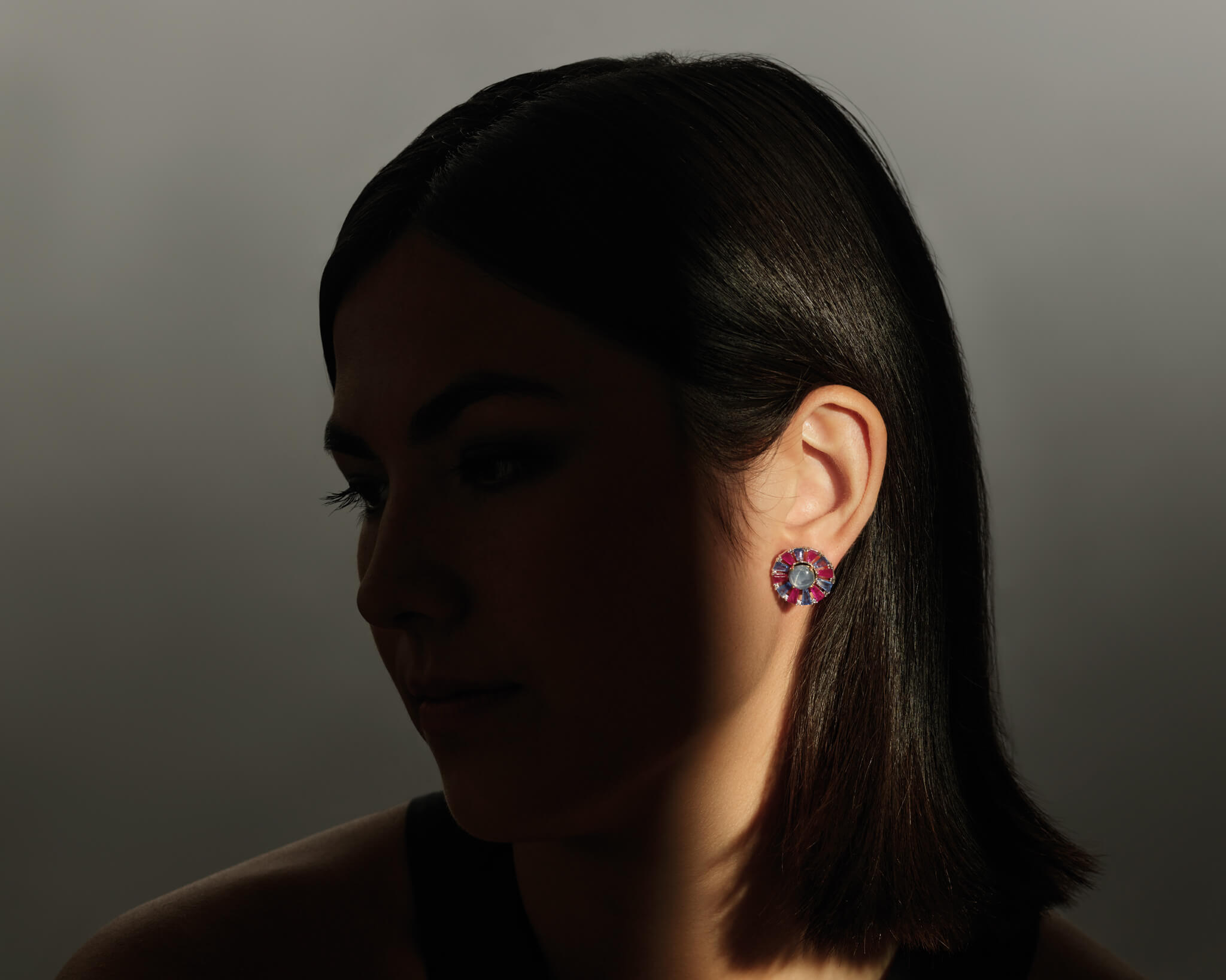 Model wears the Roi Soleil earring halos in 18ct white gold with ruby, sapphire and precious stone