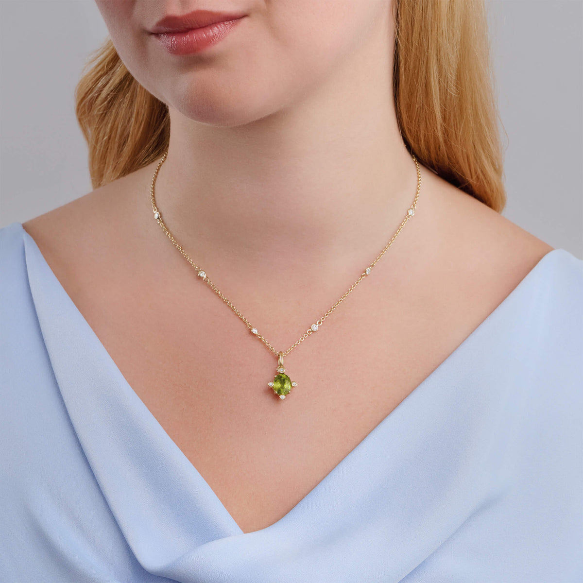Model wears handcrafted Compass medium necklace pendant in 18ct yellow gold with green sphene set with four diamonds.