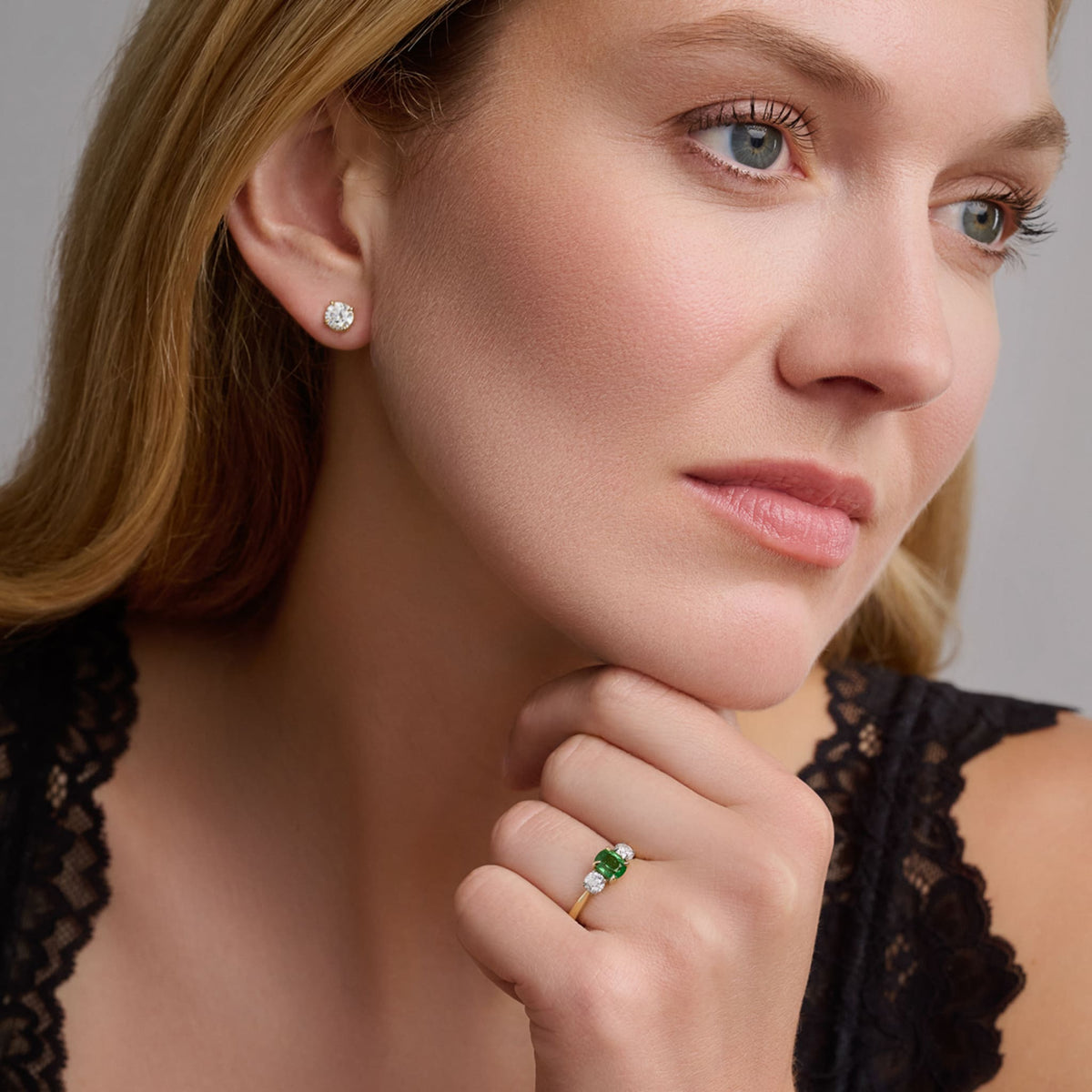 Model wears handcrafted Delilah engagement ring in 18ct yellow and white gold with green sapphire and diamond. September birthstone.