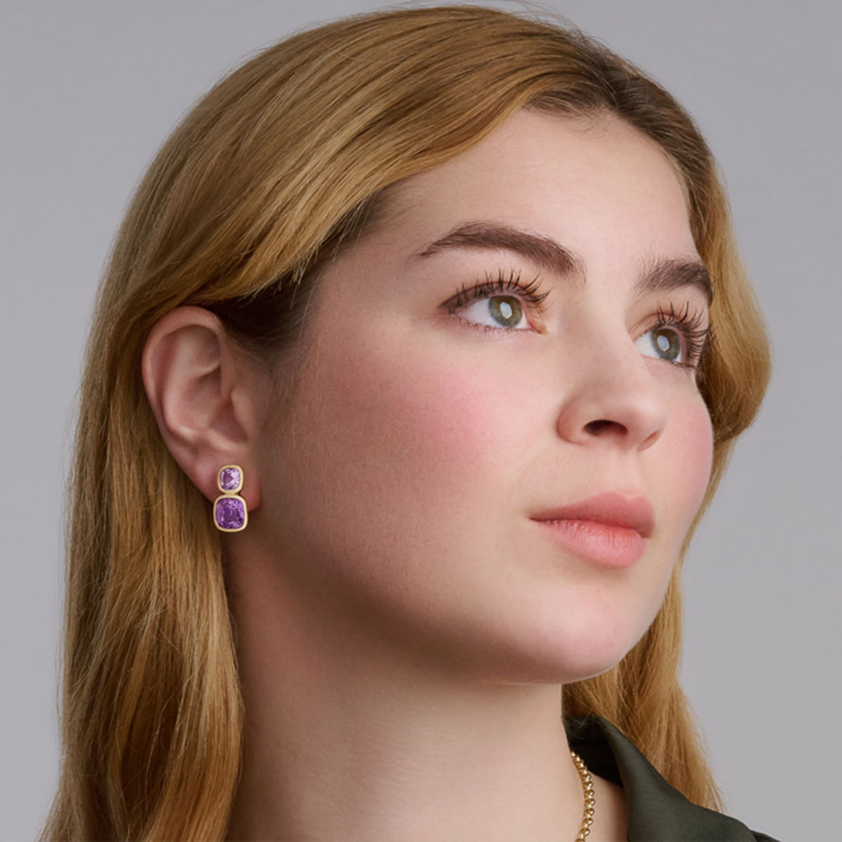 Model wears handcrafted Qin & Han earrings in 18ct yellow gold with peridot and citrine, birthstones of August and November