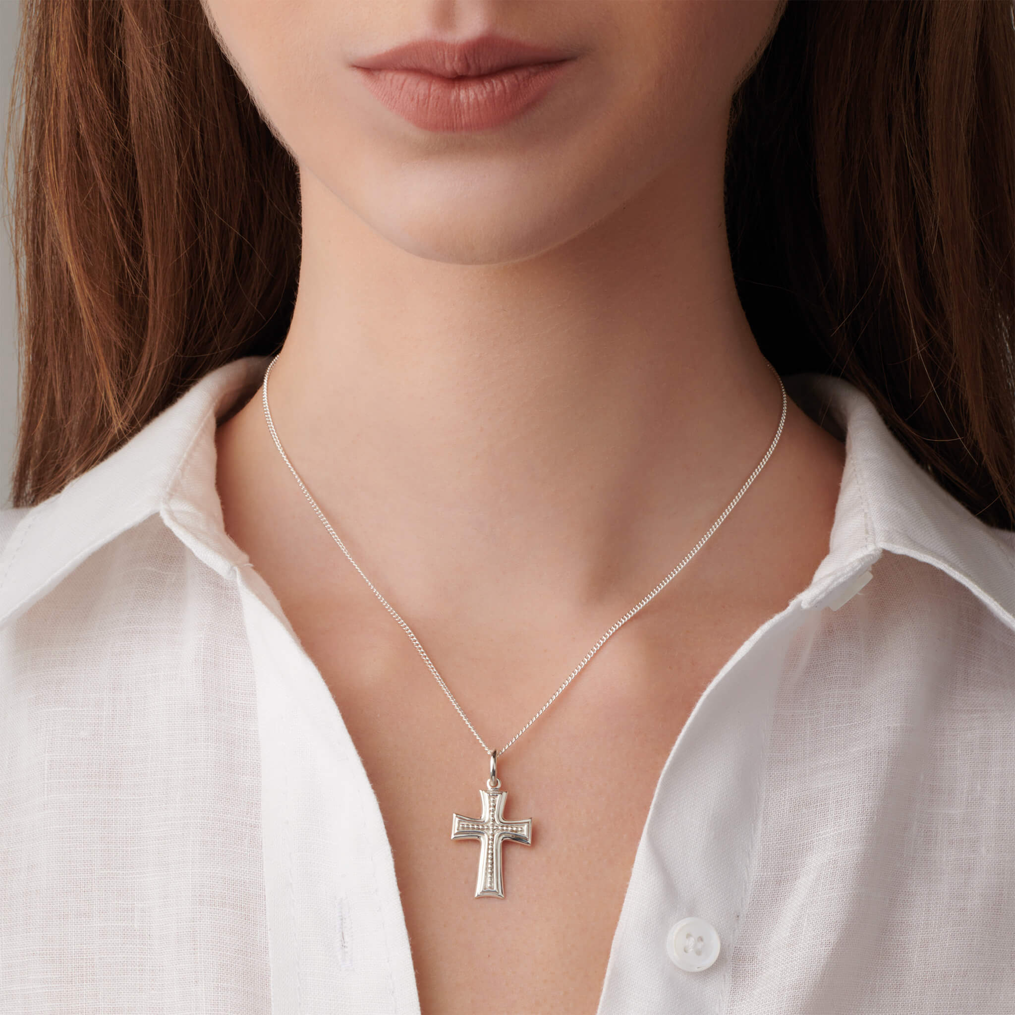 Model wears handcrafted silver cross necklace pendant inspired by the Shipka pass in Bulgaria