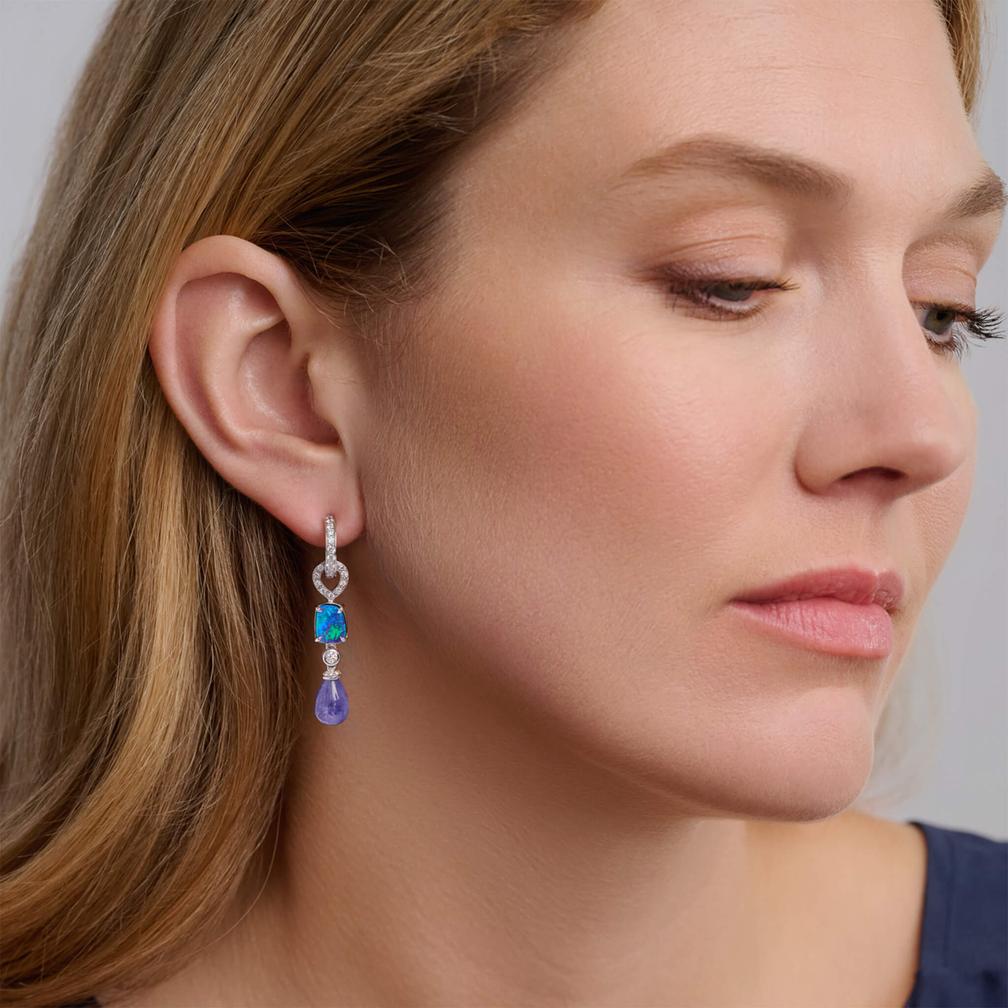 Handcrafted 18ct white gold earring drops featuring drops of blue opal and tanzanite with diamonds.