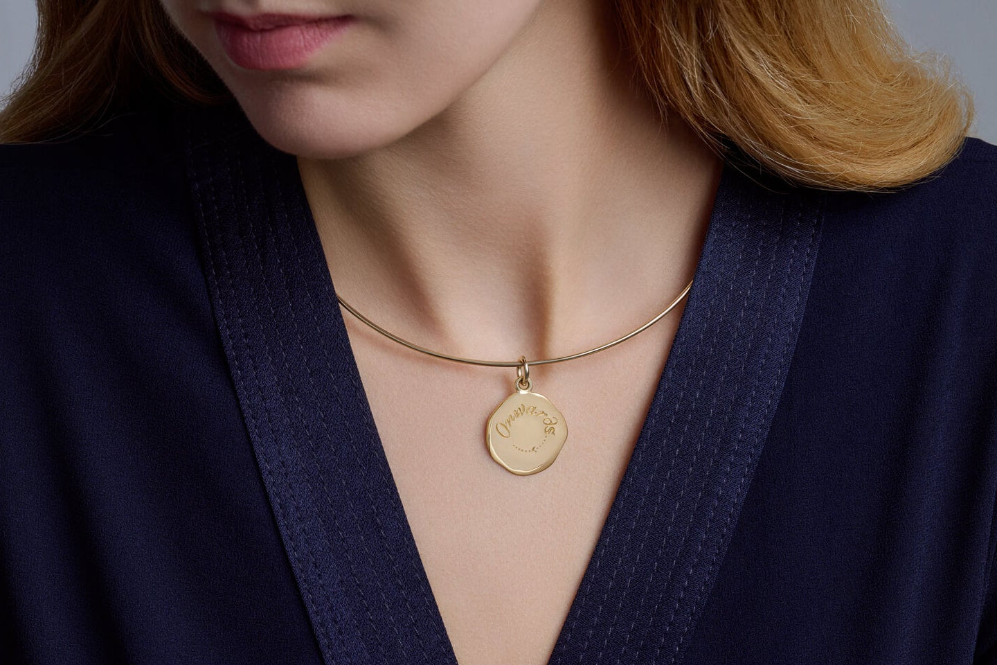 Pippa wearing yellow gold Onwards quote pendant on the Calypso troque necklace by Cassandra Goad.