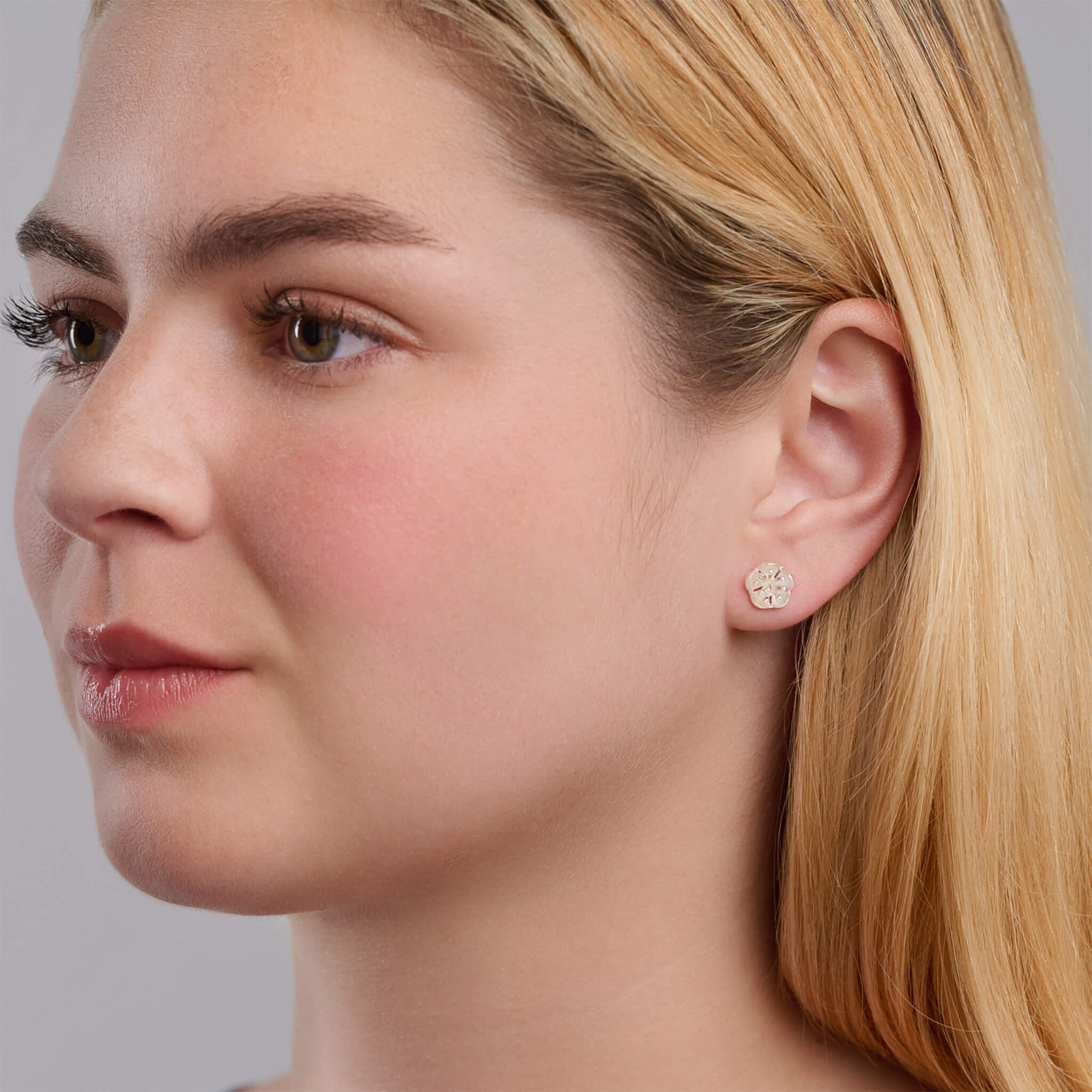 Handcrafted sterling silver earrings featuring a plum blossom shape.