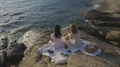 Models enjoying picnic in greece in Cassandra Goad jewels 