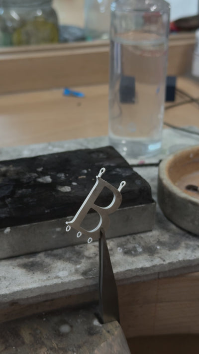 Anne Boleyn 'B' necklace crafted by hand in Cassandra Goad's London workshop. 